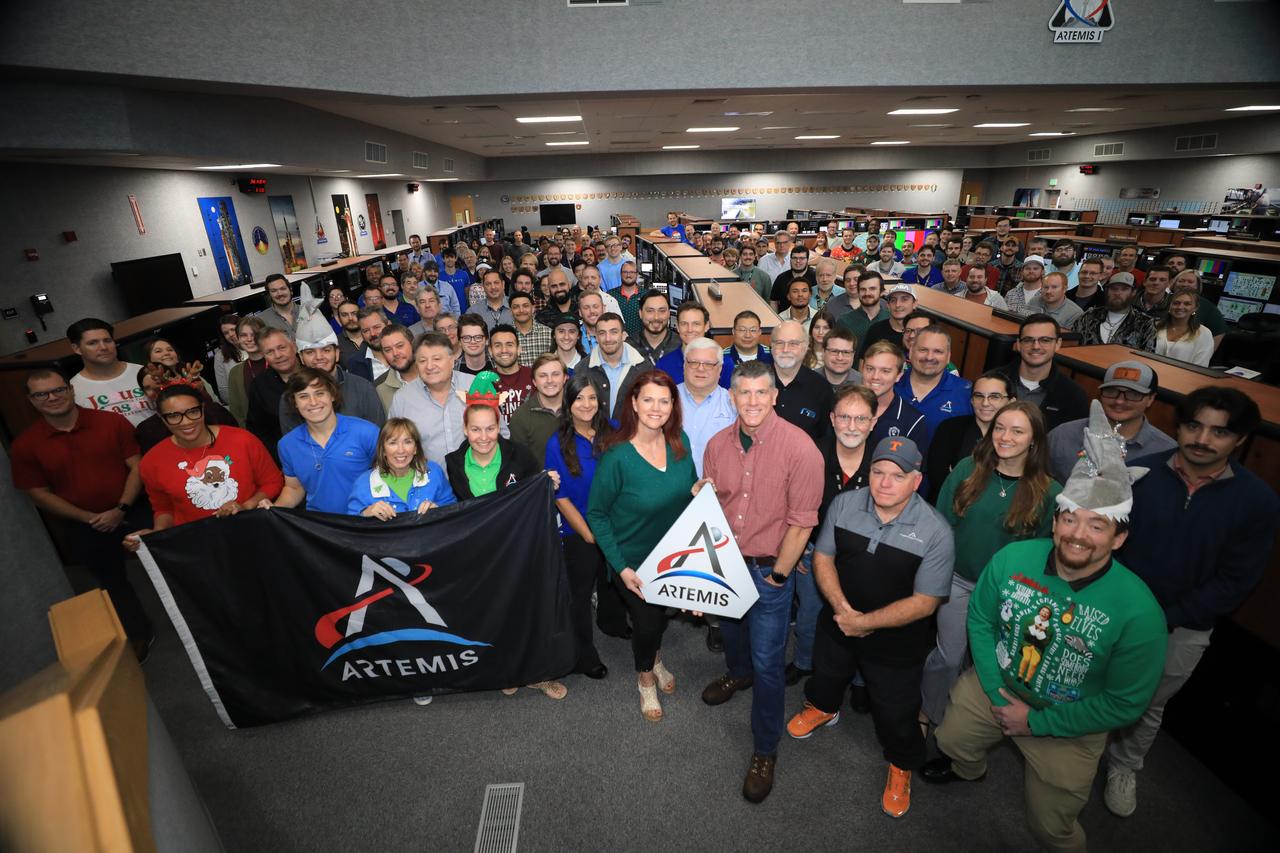 Members of the Artemis launch team pose for a holiday group photo in Firing Room 1 inside the Launch Control Center at NASA’s Kennedy Space Center in Florida on Wednesday, Dec. 11, 2024. Teams participated in a cryogenic and terminal count simulation for Artemis II. The simulations go through launch day scenarios to help launch team members test software and make any necessary adjustments during countdown operations. Four astronauts will venture around the Moon on Artemis II, the first crewed mission on NASA’s path to establishing a long-term presence for science and exploration through Artemis.