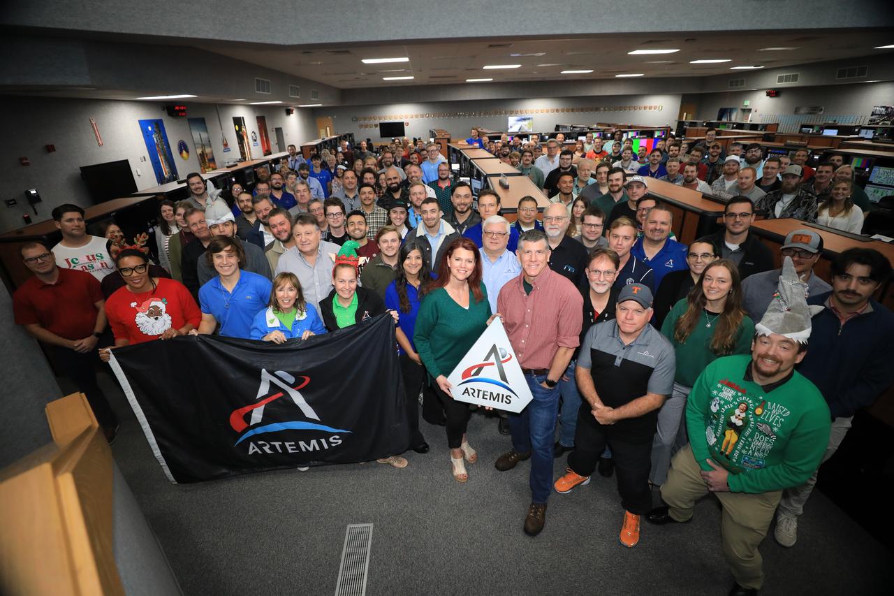 Members of the Artemis launch team pose for a holiday group photo in Firing Room 1 inside the Launch Control Center at NASA’s Kennedy Space Center in Florida on Wednesday, Dec. 11, 2024. Teams participated in a cryogenic and terminal count simulation for Artemis II. The simulations go through launch day scenarios to help launch team members test software and make any necessary adjustments during countdown operations. Four astronauts will venture around the Moon on Artemis II, the first crewed mission on NASA’s path to establishing a long-term presence for science and exploration through Artemis.