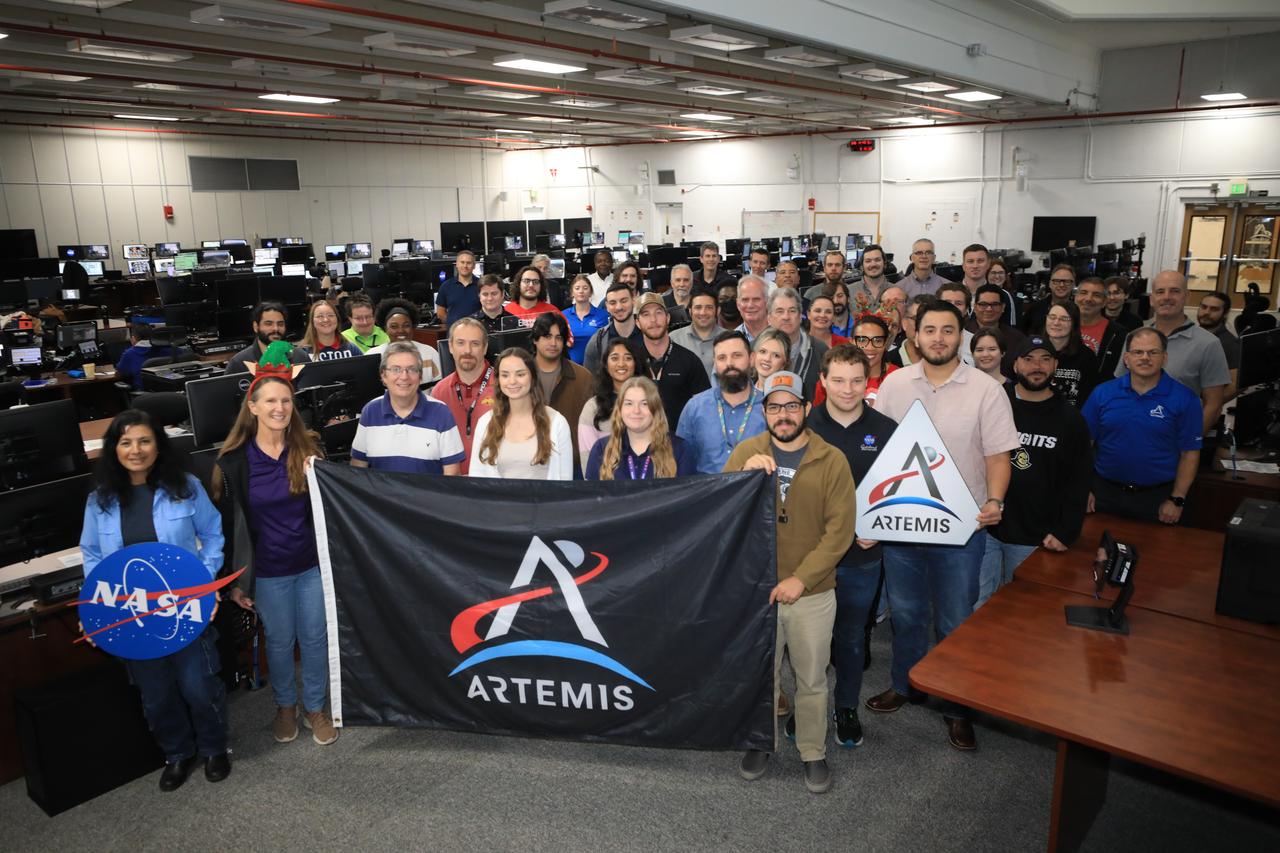 Members of the Artemis launch team pose for a holiday group photo in Firing Room 2 inside the Launch Control Center at NASA’s Kennedy Space Center in Florida on Wednesday, Dec. 11, 2024. Teams participated in a cryogenic and terminal count simulation for Artemis II. The simulations go through launch day scenarios to help launch team members test software and make any necessary adjustments during countdown operations. Four astronauts will venture around the Moon on Artemis II, the first crewed mission on NASA’s path to establishing a long-term presence for science and exploration through Artemis.