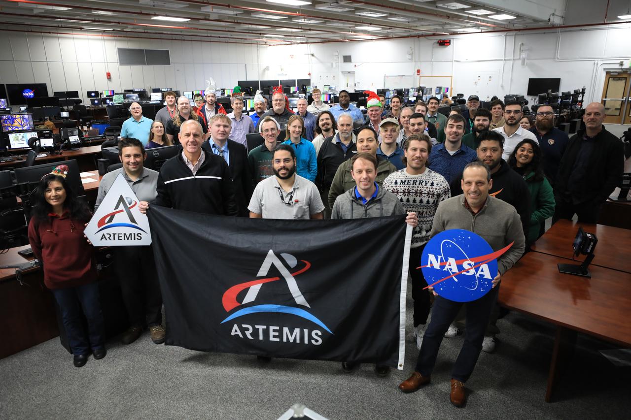 Members of the Artemis launch team pose for a holiday group photo in Firing Room 2 inside the Launch Control Center at NASA’s Kennedy Space Center in Florida on Thursday, Dec. 12, 2024. Teams participated in a cryogenic and terminal count simulation for Artemis II. The simulations go through launch day scenarios to help launch team members test software and make any necessary adjustments during countdown operations. Four astronauts will venture around the Moon on Artemis II, the first crewed mission on NASA’s path to establishing a long-term presence for science and exploration through Artemis.