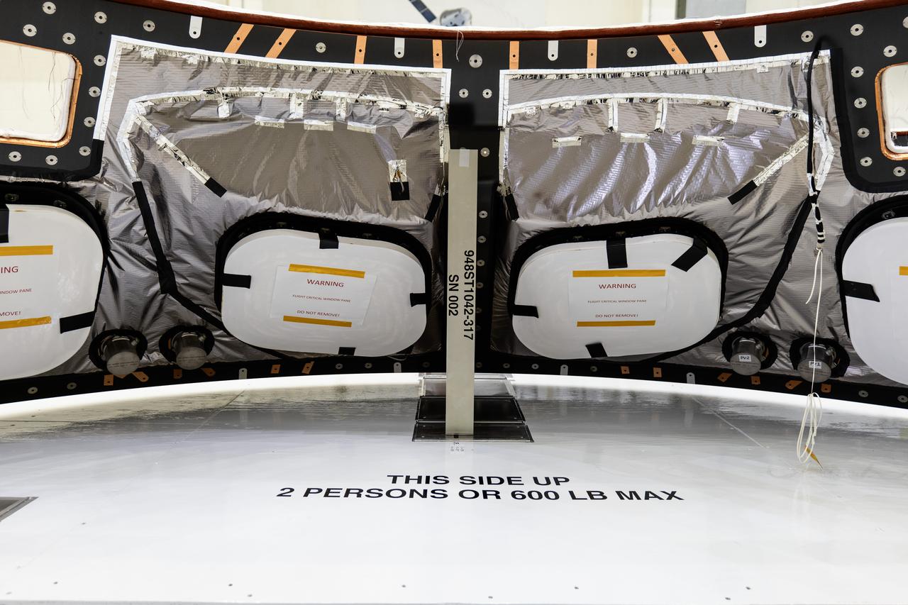 Back shell panels are visible on the Orion spacecraft for the Artemis II mission inside the Neil A. Armstrong Operations and Checkout Building high bay at NASA's Kennedy Space Center in Florida on Monday, Dec. 15, 2024. The back shell panels serve as the outer layer of the spacecraft and will protect it against the extreme temperatures of re-entry from deep space.
