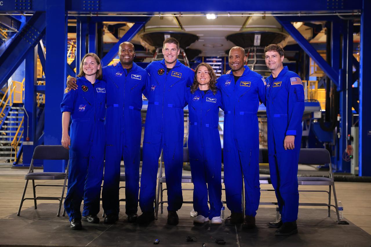 From left, CSA (Canadian Space Agency) astronaut Jenni Gibbons, NASA astronaut Andre Douglas, CSA astronaut Jeremy Hansen, and NASA astronauts Christina Koch, Victor Glover, and Reid Wiseman participate in a media day event on Monday, Dec. 16, 2024, inside the Vehicle Assembly Building at the agency’s Kennedy Space Center in Florida. The Artemis II crew and backup crew participated in the event days after teams with NASA’s Exploration Ground Systems transport lifted the agency’s 212-foot-tall SLS (Space Launch System) core stage from the facility’s transfer aisle into High Bay 2 where it will remain while teams stack the two solid rocket boosters on top of mobile launcher 1.