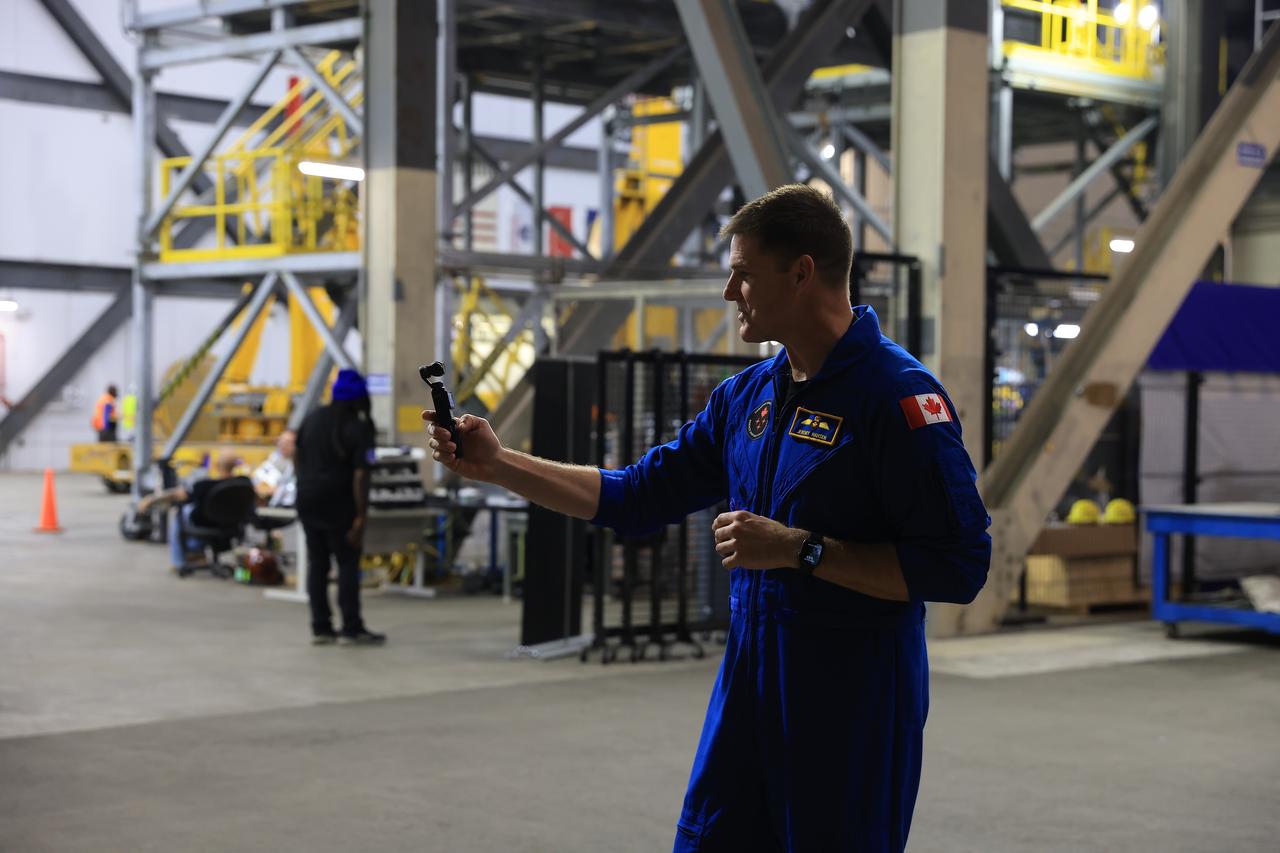 Artemis II crew member CSA (Canadian Space Agency) astronaut Jeremy Hansen participates in a media day event on Monday, Dec. 16, 2024, inside the Vehicle Assembly Building at the agency’s Kennedy Space Center in Florida. The Artemis II crew and backup crew participated in the event days after teams with NASA’s Exploration Ground Systems transport lifted the agency’s 212-foot-tall SLS (Space Launch System) core stage from the facility’s transfer aisle into High Bay 2 where it will remain while teams stack the two solid rocket boosters on top of mobile launcher 1.