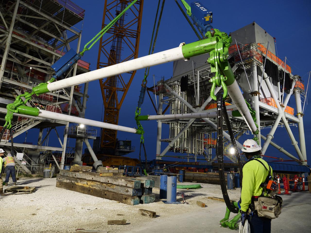 Teams at Bechtel National, Inc. use a crane to lift Module 4 into place atop the mobile launcher 2 tower chair at its Kennedy Space Center park site on January 3, 2025. Module 4 is the first of seven modules that will be stacked vertically to make up the almost 400-foot launch tower that will be used beginning with the Artemis IV mission.