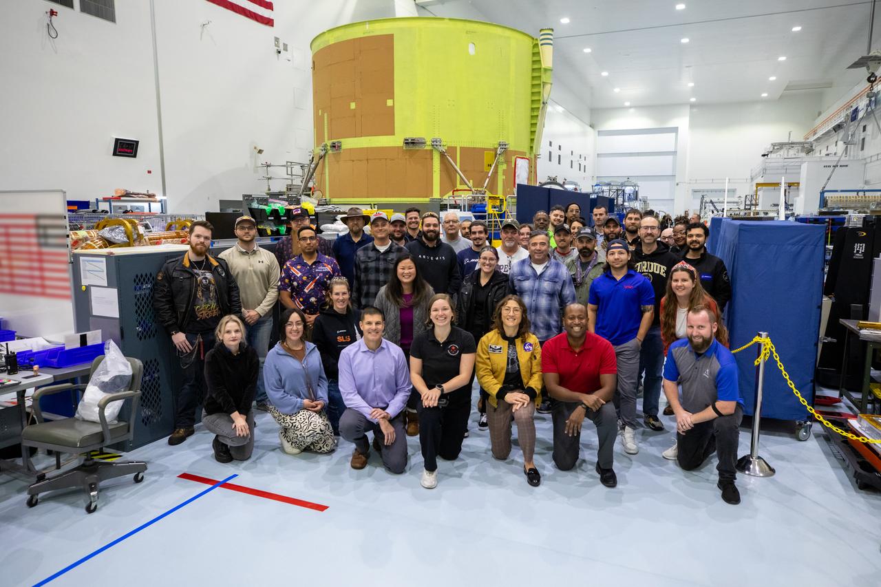 Members and backup members of the Artemis II team, along with technicians pose, for a photo with the Artemis III engine section in the background, during a visit to Kennedy Space Center in Florida on Thursday, Jan. 16, 2025. For Artemis II, four astronauts will venture around the Moon, the first crewed mission on NASA’s path to establishing a long-term presence for science and exploration through Artemis.