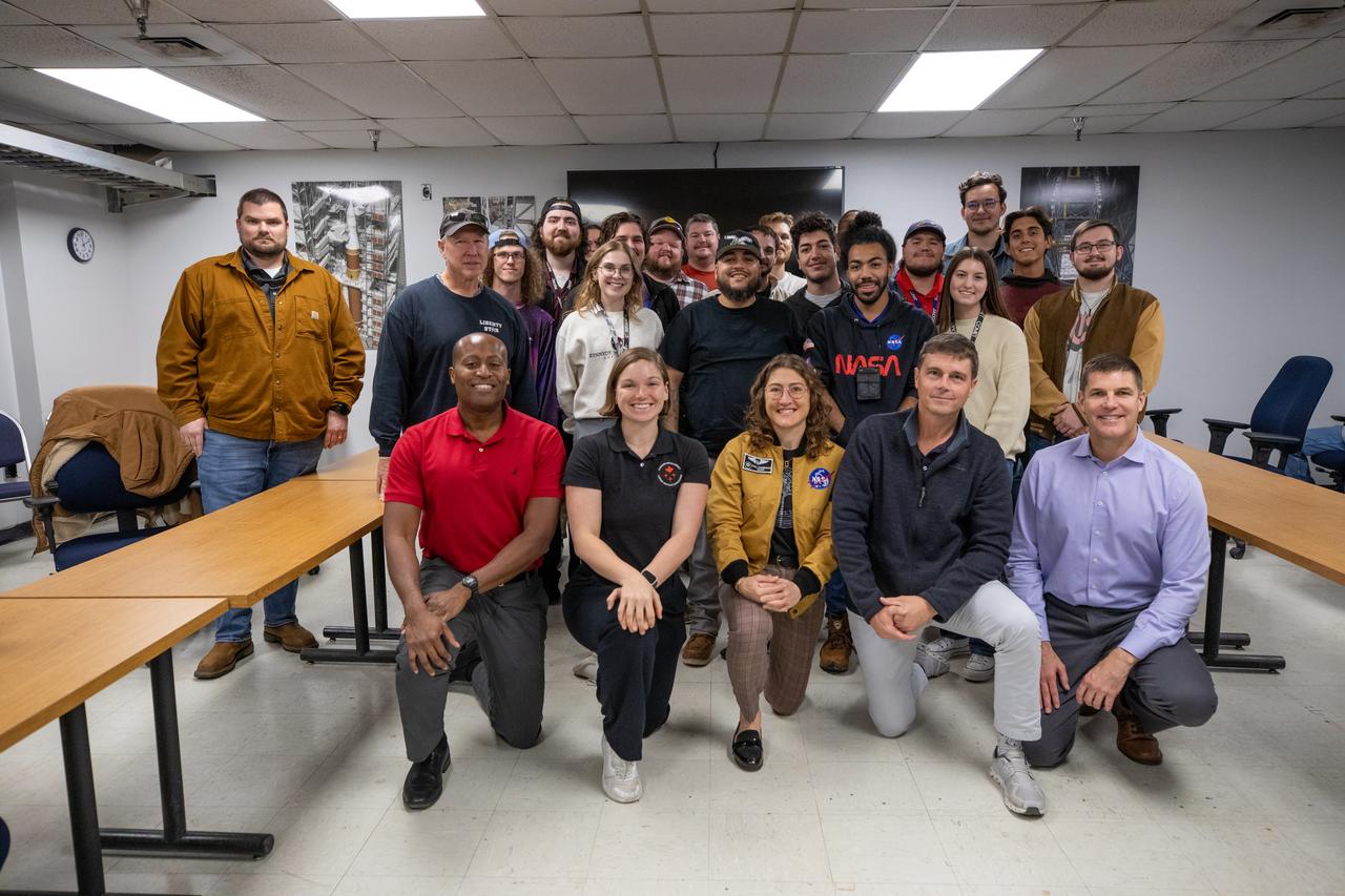 In front, from left, Andre Douglas, NASA’s Artemis II backup crew member; CSA (Canadian Space Agency) astronaut Jenni Gibbons, Artemis II backup crew member; NASA astronaut Christina Koch, Artemis II mission specialist; NASA astronaut Reid Wiseman, Artemis II commander; and Jeremy Hansen, Artemis II mission specialist pose, for a photo with NASA’s Exploration Ground Systems team during a visit to Kennedy Space Center in Florida on Thursday, Jan. 16, 2025.  For Artemis II, four astronauts will venture around the Moon, the first crewed mission on NASA’s path to establishing a long-term presence for science and exploration through Artemis.