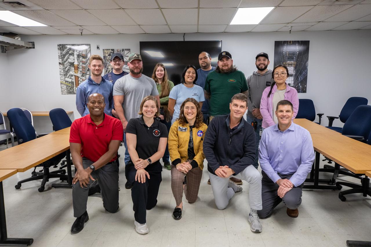 In front, from left, Andre Douglas, NASA’s Artemis II backup crew member; CSA (Canadian Space Agency) astronaut Jenni Gibbons, Artemis II backup crew member; NASA astronaut Christina Koch, Artemis II mission specialist; NASA astronaut Reid Wiseman, Artemis II commander; and Jeremy Hansen, Artemis II mission specialist pose, for a photo with NASA’s Exploration Ground Systems team during a visit to Kennedy Space Center in Florida on Thursday, Jan. 16, 2025.  For Artemis II, four astronauts will venture around the Moon, the first crewed mission on NASA’s path to establishing a long-term presence for science and exploration through Artemis.
