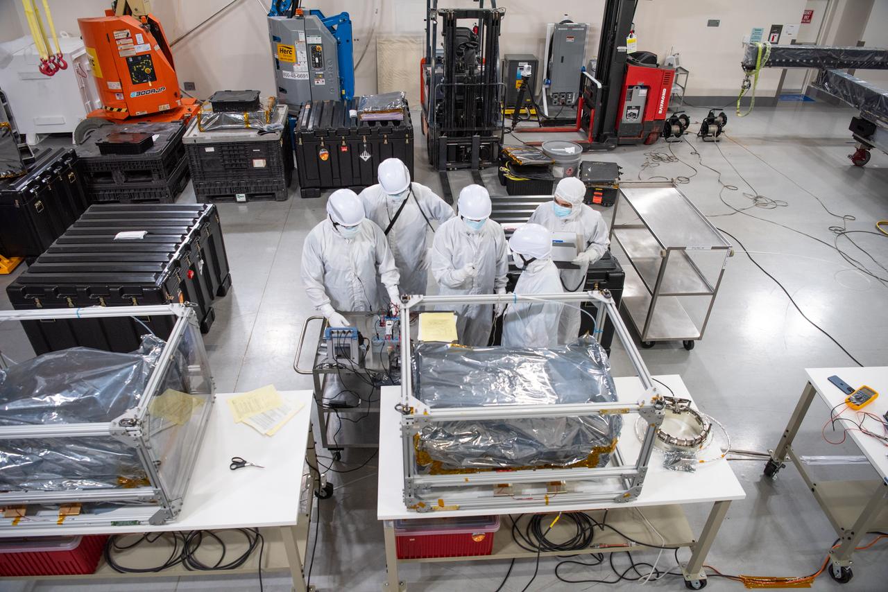 Technicians conduct testing operations on NASA’s PUNCH (Polarimeter to Unify the Corona and Heliosphere) spacecraft onto a work stand for testing operations at the Astrotech Processing Facility on Vandenberg Space Force Base in California on Sunday, Jan. 19, 2025. PUNCH, consisting of four satellites, will produce continuous 3D images of the solar wind and solar storms as it travels from the Sun to Earth to better understand how material in the corona accelerates to become the solar wind that fills the solar system. PUNCH will launch aboard a SpaceX Falcon 9 rocket in late February 2025.
