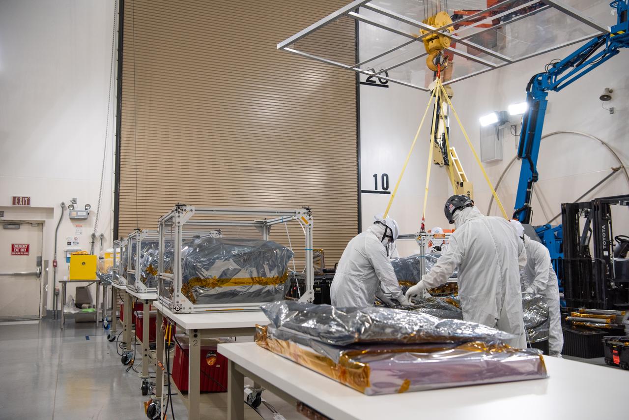 Technicians use an overheard crane to lift NASA’s PUNCH (Polarimeter to Unify the Corona and Heliosphere) spacecraft onto a work stand for testing operations at the Astrotech Processing Facility on Vandenberg Space Force Base in California on Sunday, Jan. 19, 2025. PUNCH, consisting of four satellites, will produce continuous 3D images of the solar wind and solar storms as it travels from the Sun to Earth to better understand how material in the corona accelerates to become the solar wind that fills the solar system. PUNCH will launch aboard a SpaceX Falcon 9 rocket in late February 2025.