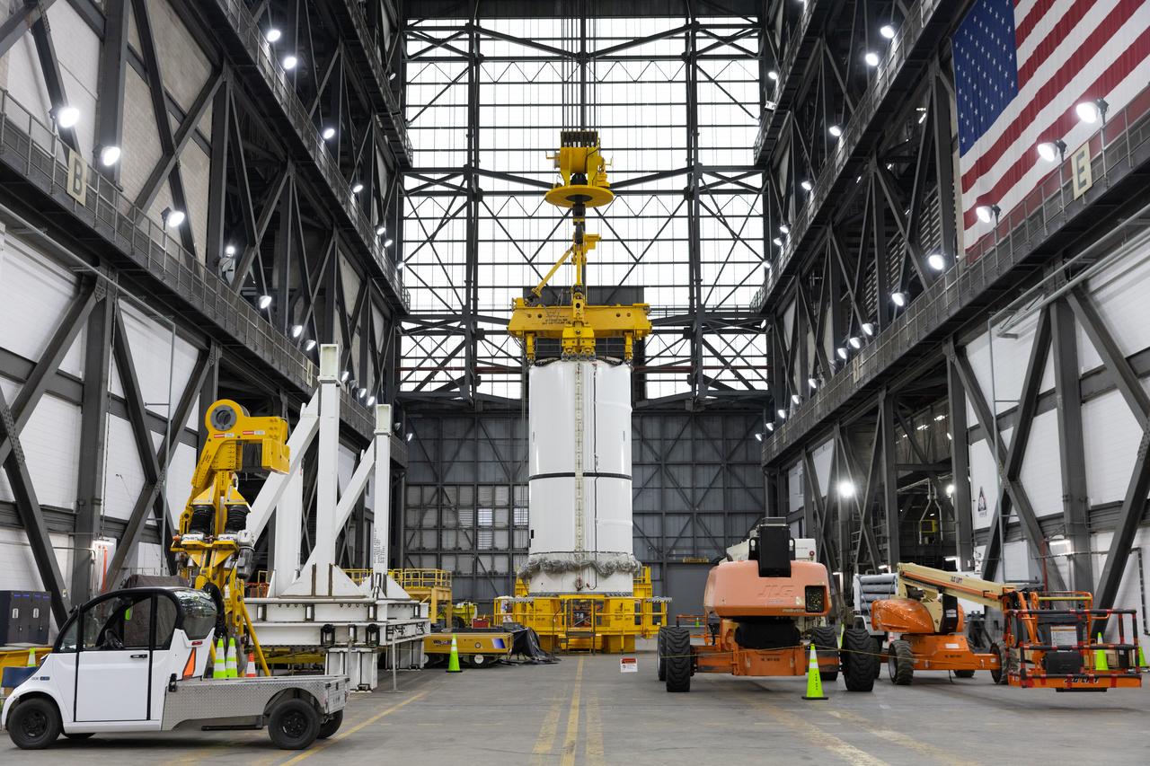 Engineers and technicians with NASA's Exploration Ground Systems Program transfer the right forward center segment to the Vehicle Assembly Building at NASA's Kennedy Space Center in Florida. The booster segment is shown attached to a lifting beam on Tuesday, Jan. 21, 2025 ahead of integration onto the Mobile Launcher 1. The boosters will help support the remaining rocket components and the Orion spacecraft during final assembly of the Artems II Moon rocket and provide more than 75 percent of the total SLS (Space Launch System) thrust during liftoff from NASA Kennedy's Launch Pad 39B.