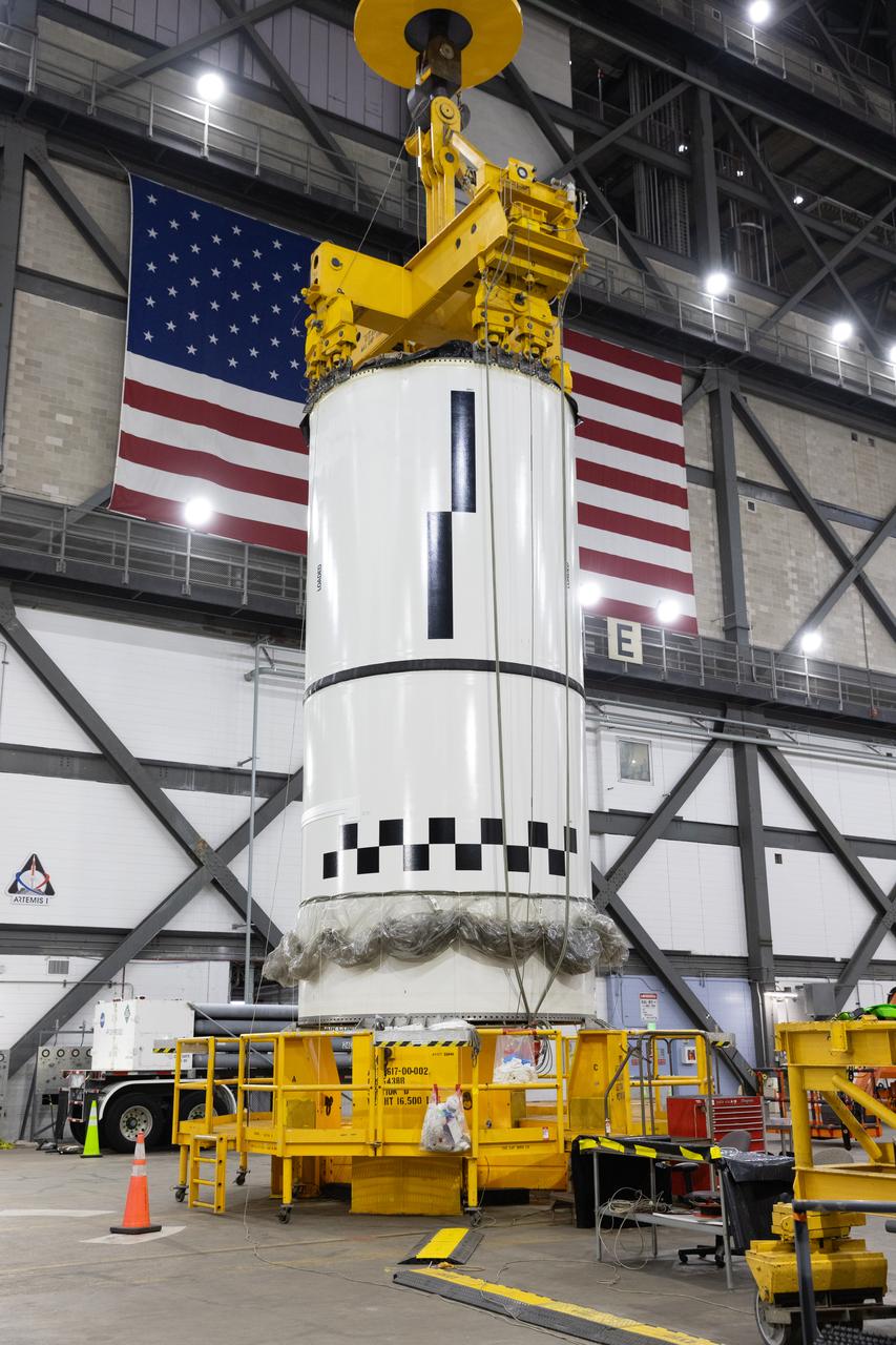 Engineers and technicians with NASA's Exploration Ground Systems Program transfer the right forward center segment to the Vehicle Assembly Building at NASA's Kennedy Space Center in Florida. The booster segment is shown attached to a lifting beam on Tuesday, Jan. 21, 2025 ahead of integration onto the Mobile Launcher 1. The boosters will help support the remaining rocket components and the Orion spacecraft during final assembly of the Artems II Moon rocket and provide more than 75 percent of the total SLS (Space Launch System) thrust during liftoff from NASA Kennedy's Launch Pad 39B.