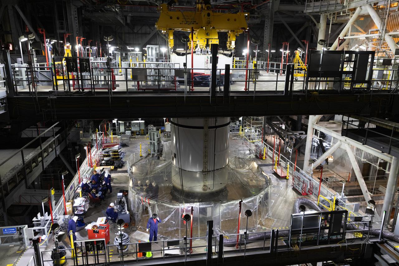 Engineers and technicians with NASA's Exploration Ground Systems Program transfer the right forward center segment to the Vehicle Assembly Building at NASA's Kennedy Space Center in Florida. The booster segment is shown attached to a lifting beam on Tuesday, Jan. 22, 2025 ahead of integration onto the Mobile Launcher 1. The boosters will help support the remaining rocket components and the Orion spacecraft during final assembly of the Artems II Moon rocket and provide more than 75 percent of the total SLS (Space Launch System) thrust during liftoff from NASA Kennedy's Launch Pad 39B.