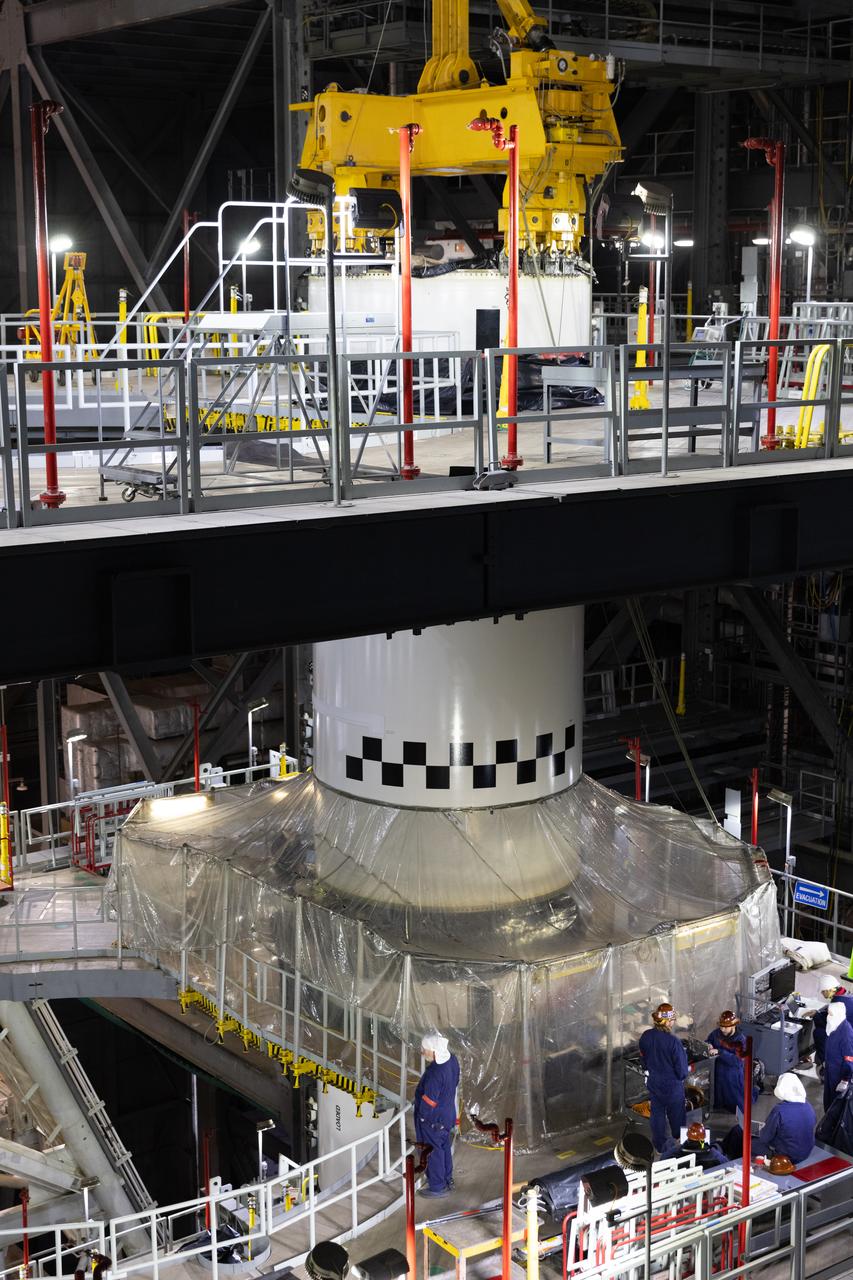 Engineers and technicians with NASA's Exploration Ground Systems Program transfer the right forward center segment to the Vehicle Assembly Building at NASA's Kennedy Space Center in Florida. The booster segment is shown attached to a lifting beam on Tuesday, Jan. 22, 2025 ahead of integration onto the Mobile Launcher 1. The boosters will help support the remaining rocket components and the Orion spacecraft during final assembly of the Artems II Moon rocket and provide more than 75 percent of the total SLS (Space Launch System) thrust during liftoff from NASA Kennedy's Launch Pad 39B.