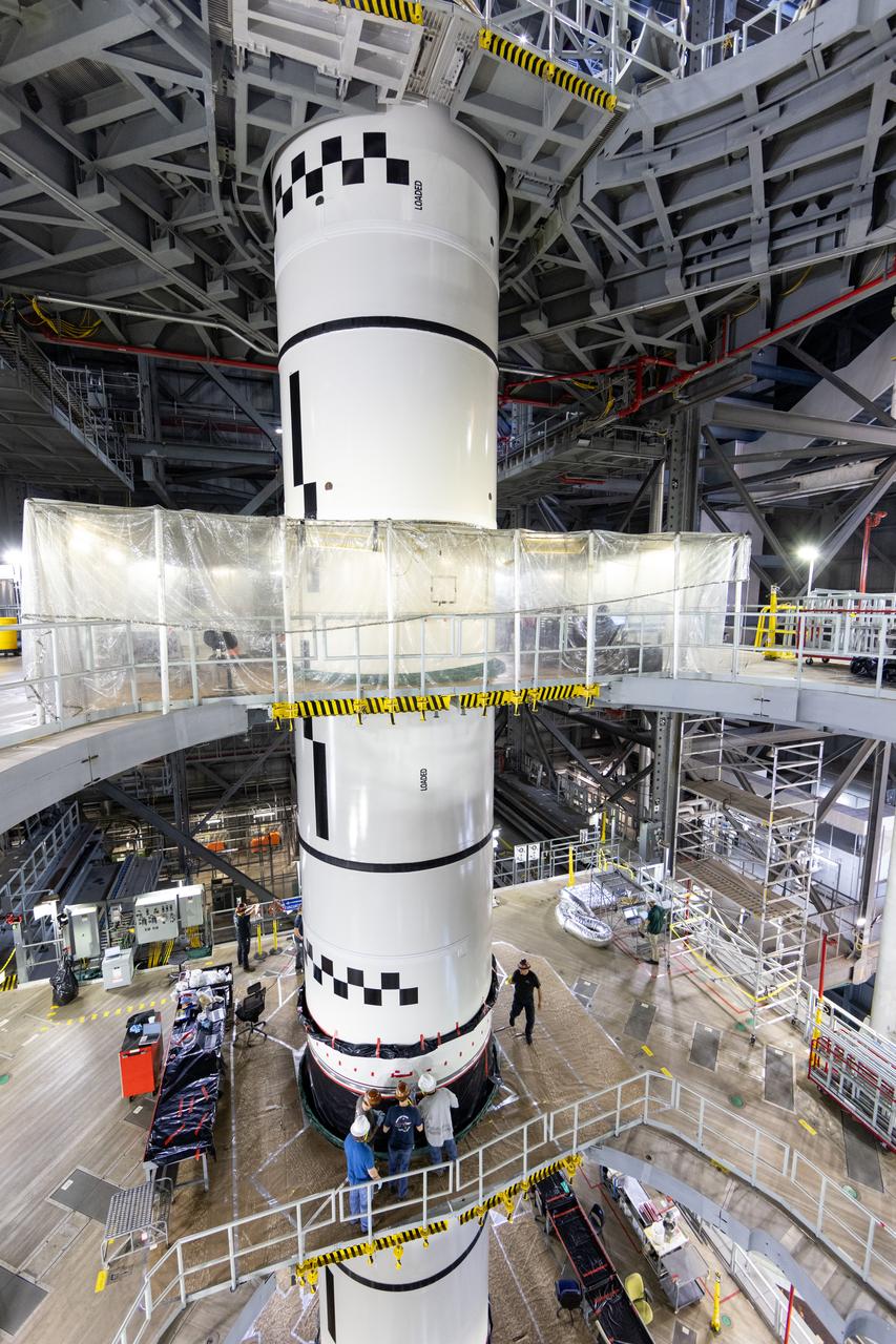 Technicians with NASA’s Exploration Ground Systems complete the integration of the left forward segment to the center forward segment on mobile launcher 1 inside the Vehicle Assembly Building at the agency’s Kennedy Space Center in Florida on Friday, Feb. 7, 2025. The twin solid boosters, five segments on each side, will help support the remaining rocket components and the Orion spacecraft during final assembly of the Artemis II Moon rocket and provide more than 75 percent of the total SLS thrust during liftoff from NASA Kennedy’s Launch Pad 39B. 