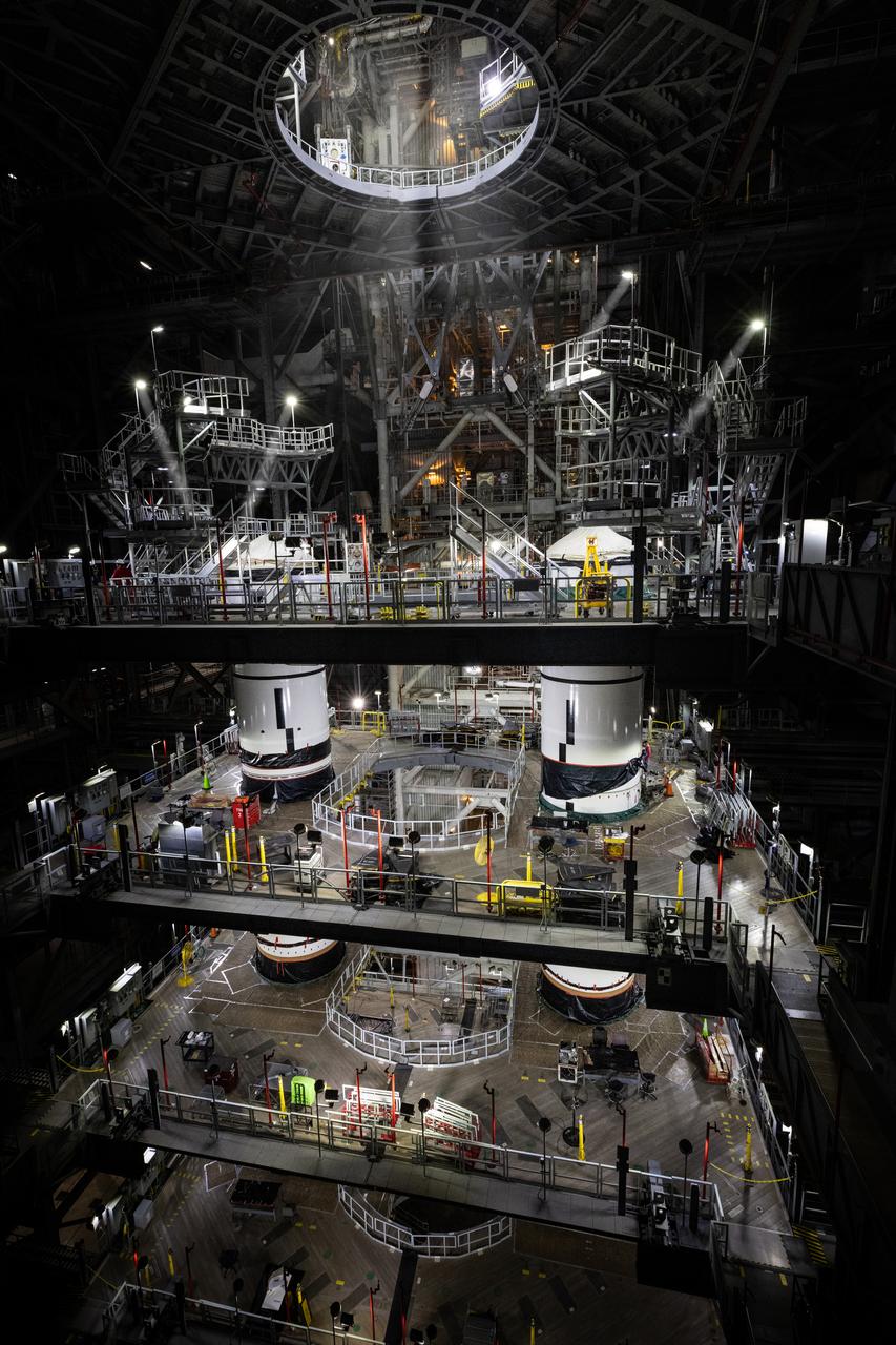 Technicians with Exploration Ground Systems integrate the right forward segment atop the center forward segment on NASA’s SLS (Space Launch System) Moon rocket booster inside the Vehicle Assembly Building’s High Bay 3 at Kennedy Space Center in Florida on Friday, Feb. 14, 2025. The twin solid boosters, five segments on each side, will help support the remaining rocket components and the Orion spacecraft during final assembly of the Artemis II Moon rocket and provide more than 75 percent of the total SLS thrust during liftoff from NASA Kennedy’s Launch Pad 39B.