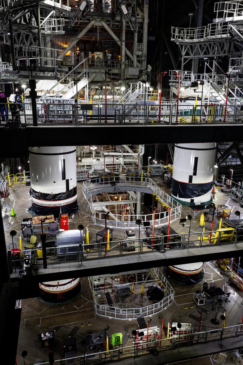 Technicians with Exploration Ground Systems integrate the right forward segment atop the center forward segment on NASA’s SLS (Space Launch System) Moon rocket booster inside the Vehicle Assembly Building’s High Bay 3 at Kennedy Space Center in Florida on Friday, Feb. 14, 2025. The twin solid boosters, five segments on each side, will help support the remaining rocket components and the Orion spacecraft during final assembly of the Artemis II Moon rocket and provide more than 75 percent of the total SLS thrust during liftoff from NASA Kennedy’s Launch Pad 39B.