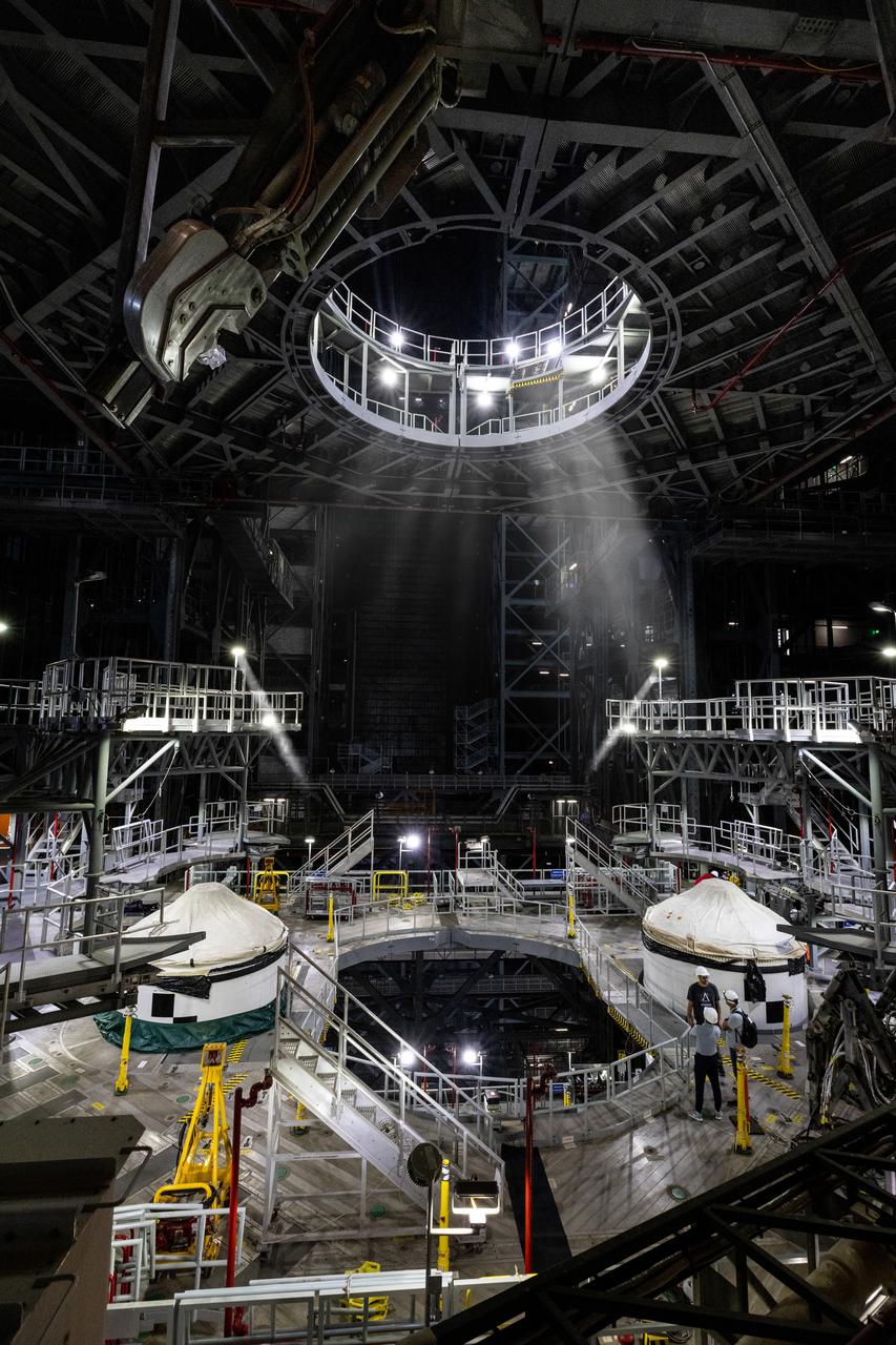 Technicians with Exploration Ground Systems integrate the right forward segment atop the center forward segment on NASA’s SLS (Space Launch System) Moon rocket booster inside the Vehicle Assembly Building’s High Bay 3 at Kennedy Space Center in Florida on Friday, Feb. 14, 2025. The twin solid boosters, five segments on each side, will help support the remaining rocket components and the Orion spacecraft during final assembly of the Artemis II Moon rocket and provide more than 75 percent of the total SLS thrust during liftoff from NASA Kennedy’s Launch Pad 39B.