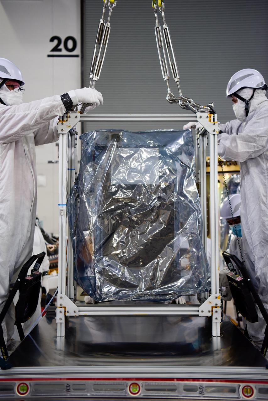 Technicians integrate NASA’s four PUNCH (Polarimeter to Unify the Corona and Heliosphere) satellites to the evolved expendable launch vehicle secondary payload adapter array ring inside the Astrotech Space Operations Facility at Vandenberg Space Force Base in California on Friday, Feb. 14, 2025. PUNCH will study origins of the Sun’s outflow of material, or the solar wind, capturing continuous 3D images of the Sun’s corona and the solar wind’s journey into the solar system. The PUNCH mission is launching as a rideshare with NASA’s SPHEREx (Spectro-Photometer for the History of the Universe, Epoch of Reionization and Ices Explorer) observatory scheduled to launch aboard a SpaceX Falcon 9 rocket at 10:09 p.m. EST (7:09 p.m. PST), Friday, Feb. 28, 2025, at Space Launch Complex 4 East from Vandenberg Space Force Base in California.