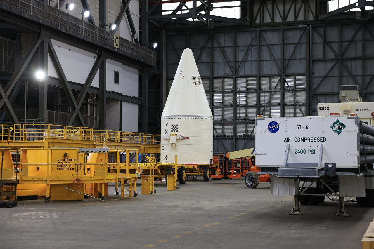 Engineers with NASA’s Exploration Ground Systems integrate the aerodynamic nose cone onto the right-hand forward assembly of the twin SLS (Space Launch System) solid rocket boosters for Artemis II inside the Vehicle Assembly Building’s High Bay 3 at NASA’s Kennedy Space Center in Florida on Tuesday, Feb. 18, 2025. Each forward assembly contains an aerodynamic top, a forward skirt housing avionics, and frustum housing motors that allow the boosters to separate from the SLS core stage after launch. The twin solid boosters will help support the remaining rocket components and the Orion spacecraft during final assembly of the Artemis II Moon rocket and provide more than 75 percent of the total SLS thrust during liftoff from NASA Kennedy’s Launch Pad 39B.