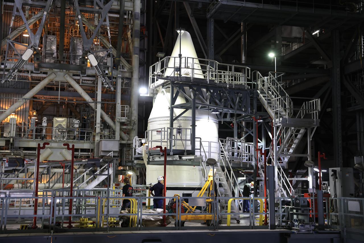 Engineers with NASA’s Exploration Ground Systems complete stacking operations on the twin SLS (Space Launch System) solid rocket boosters for Artemis II by integrating the nose cones atop the forward assemblies inside the Vehicle Assembly Building’s High Bay 3 at NASA’s Kennedy Space Center in Florida on Wednesday, Feb. 19, 2025. During three months of stacking operations, technicians used a massive overhead crane to lift 10 booster segments – five segments per booster – and aerodynamic nose cones into place on mobile launcher 1. The twin solid boosters will help support the remaining rocket components and the Orion spacecraft during final assembly of the Artemis II Moon rocket and provide more than 75 percent of the total SLS thrust during liftoff from NASA Kennedy’s Launch Pad 39B.