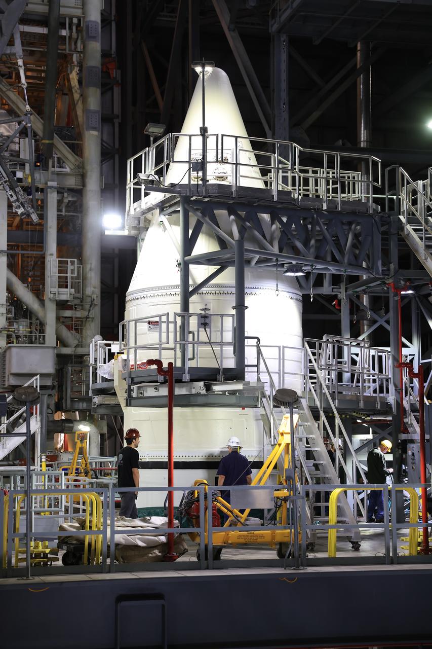 Engineers with NASA’s Exploration Ground Systems complete stacking operations on the twin SLS (Space Launch System) solid rocket boosters for Artemis II by integrating the nose cones atop the forward assemblies inside the Vehicle Assembly Building’s High Bay 3 at NASA’s Kennedy Space Center in Florida on Wednesday, Feb. 19, 2025. During three months of stacking operations, technicians used a massive overhead crane to lift 10 booster segments – five segments per booster – and aerodynamic nose cones into place on mobile launcher 1. The twin solid boosters will help support the remaining rocket components and the Orion spacecraft during final assembly of the Artemis II Moon rocket and provide more than 75 percent of the total SLS thrust during liftoff from NASA Kennedy’s Launch Pad 39B.