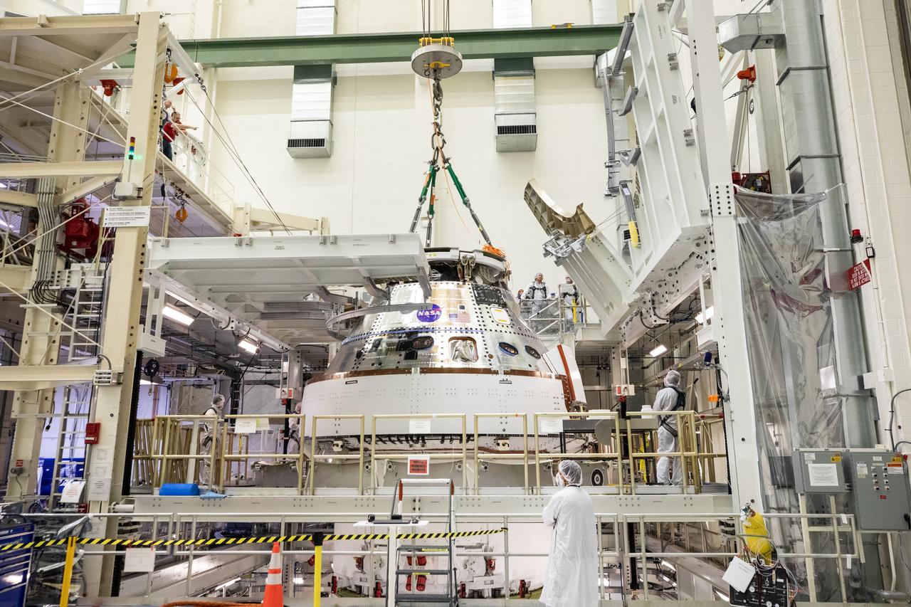 Technicians with NASA and Lockheed Martin operate a 30-ton crane to move NASA’s Artemis II Orion spacecraft out of the Final Assembly and System Testing cell inside the Neil A. Operations and Checkout Building at NASA’s Kennedy Space Center in Florida on Saturday, Feb. 22, 2025. The move prepares for the upcoming installation of four solar array wings and spacecraft adapter jettison fairings for the agency’s first crewed flight test under the Artemis campaign. 