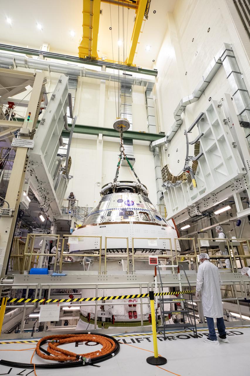 Technicians with NASA and Lockheed Martin operate a 30-ton crane to move NASA’s Artemis II Orion spacecraft out of the Final Assembly and System Testing cell inside the Neil A. Operations and Checkout Building at NASA’s Kennedy Space Center in Florida on Saturday, Feb. 22, 2025. The move prepares for the upcoming installation of four solar array wings and spacecraft adapter jettison fairings for the agency’s first crewed flight test under the Artemis campaign. 