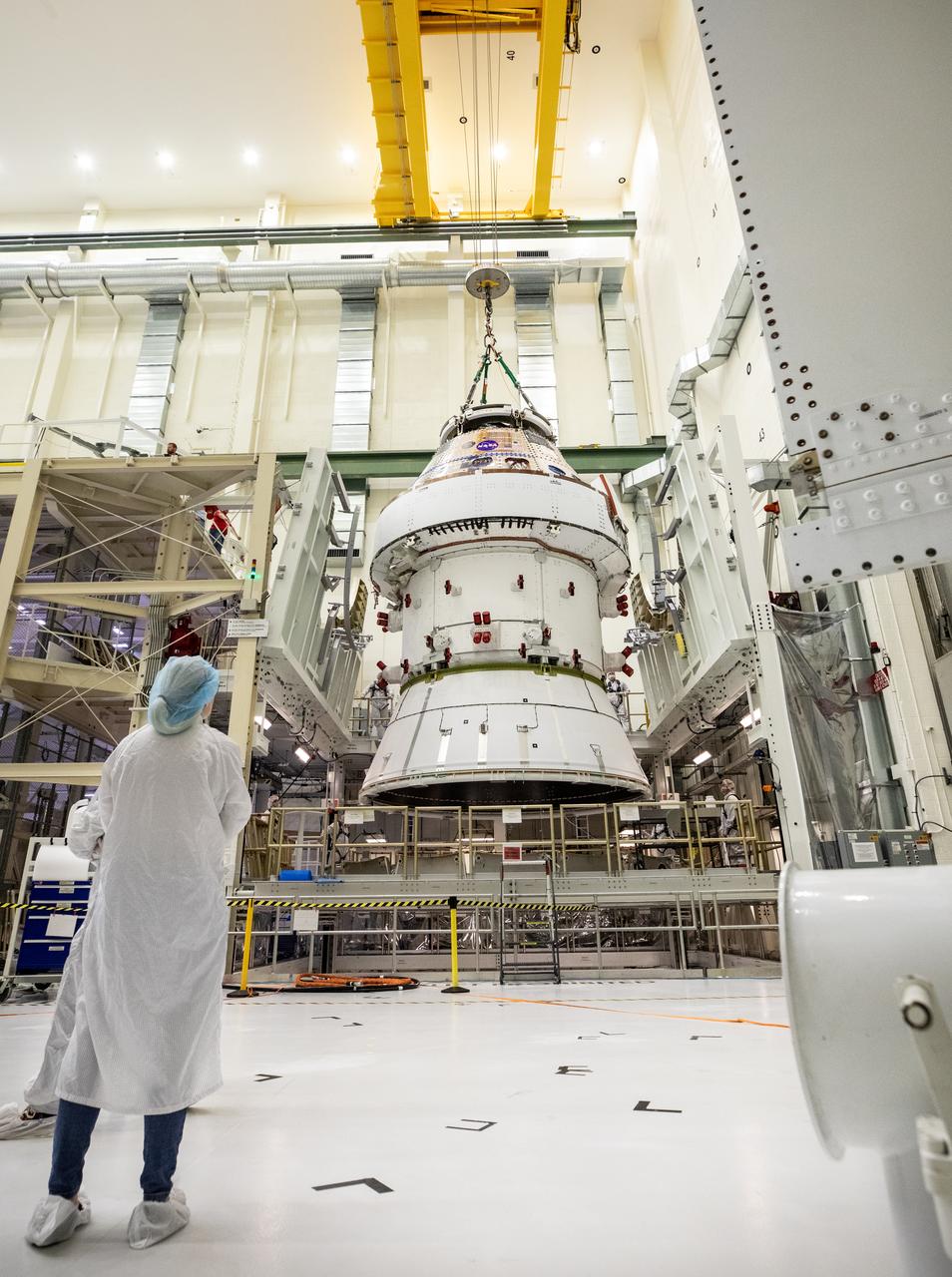 Technicians with NASA and Lockheed Martin operate a 30-ton crane to move NASA’s Artemis II Orion spacecraft out of the Final Assembly and System Testing cell inside the Neil A. Operations and Checkout Building at NASA’s Kennedy Space Center in Florida on Saturday, Feb. 22, 2025. The move prepares for the upcoming installation of four solar array wings and spacecraft adapter jettison fairings for the agency’s first crewed flight test under the Artemis campaign. 
