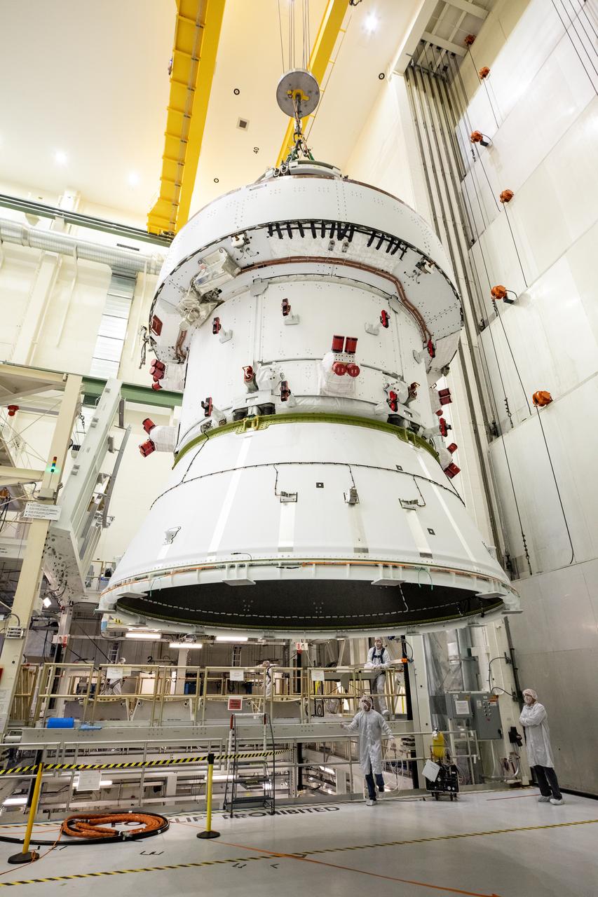 Technicians with NASA and Lockheed Martin operate a 30-ton crane to move NASA’s Artemis II Orion spacecraft out of the Final Assembly and System Testing cell inside the Neil A. Operations and Checkout Building at NASA’s Kennedy Space Center in Florida on Saturday, Feb. 22, 2025. The move prepares for the upcoming installation of four solar array wings and spacecraft adapter jettison fairings for the agency’s first crewed flight test under the Artemis campaign.