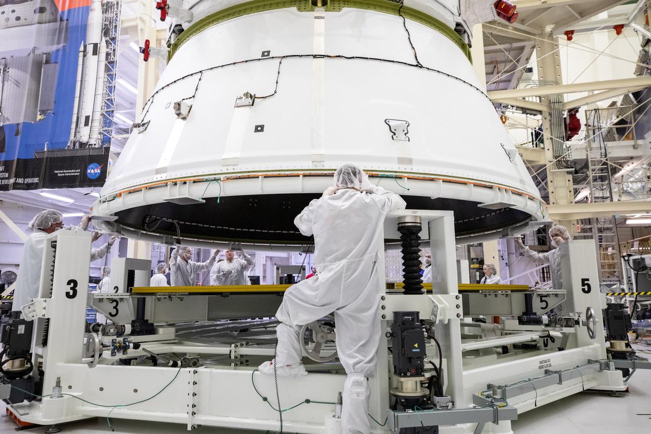 Technicians with NASA and Lockheed Martin operate a 30-ton crane to move NASA’s Artemis II Orion spacecraft out of the Final Assembly and System Testing cell inside the Neil A. Operations and Checkout Building at NASA’s Kennedy Space Center in Florida on Saturday, Feb. 22, 2025. The move prepares for the upcoming installation of four solar array wings and spacecraft adapter jettison fairings for the agency’s first crewed flight test under the Artemis campaign.