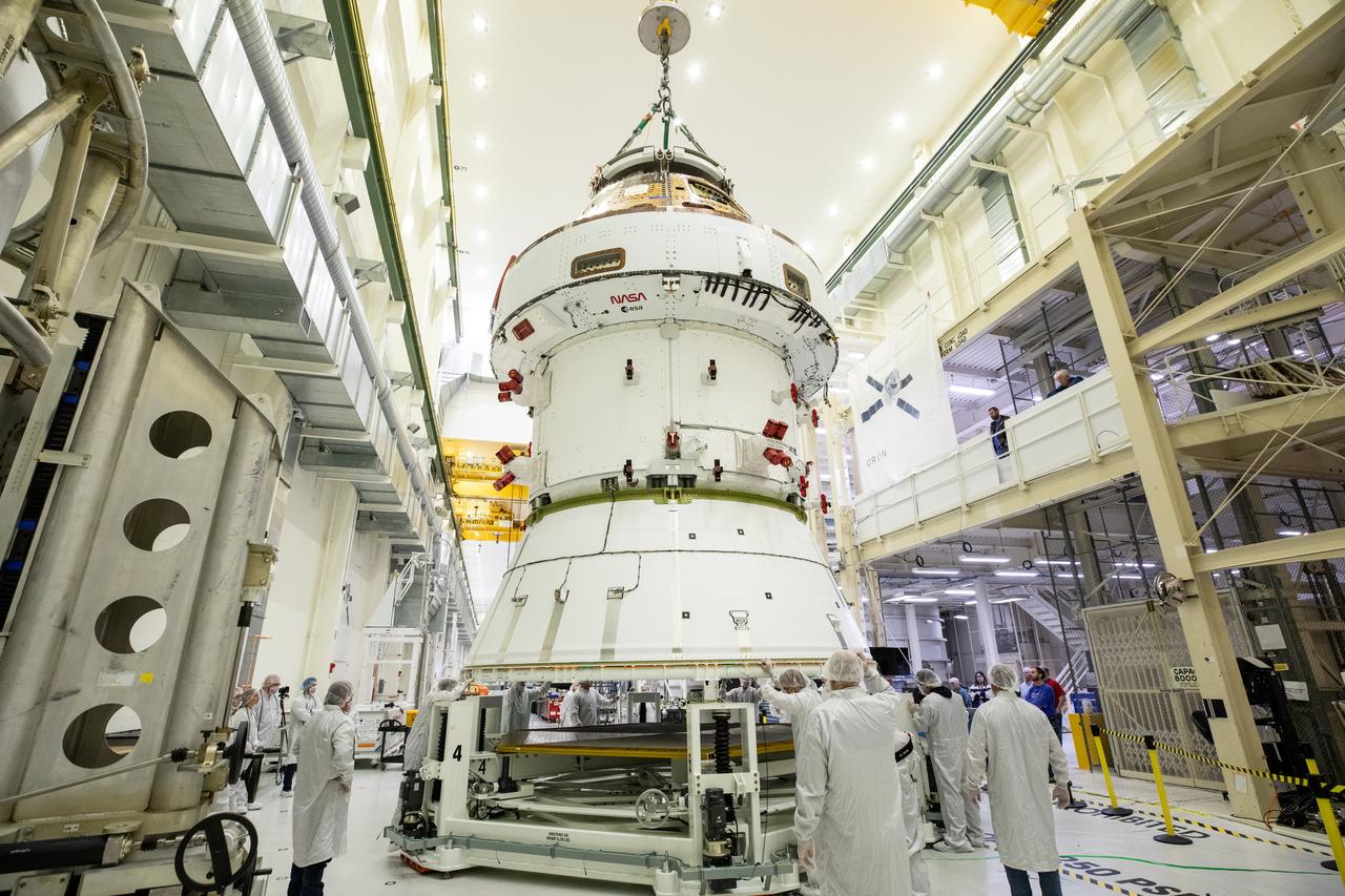 Technicians with NASA and Lockheed Martin operate a 30-ton crane to move NASA’s Artemis II Orion spacecraft out of the Final Assembly and System Testing cell inside the Neil A. Operations and Checkout Building at NASA’s Kennedy Space Center in Florida on Saturday, Feb. 22, 2025. The move prepares for the upcoming installation of four solar array wings and spacecraft adapter jettison fairings for the agency’s first crewed flight test under the Artemis campaign.