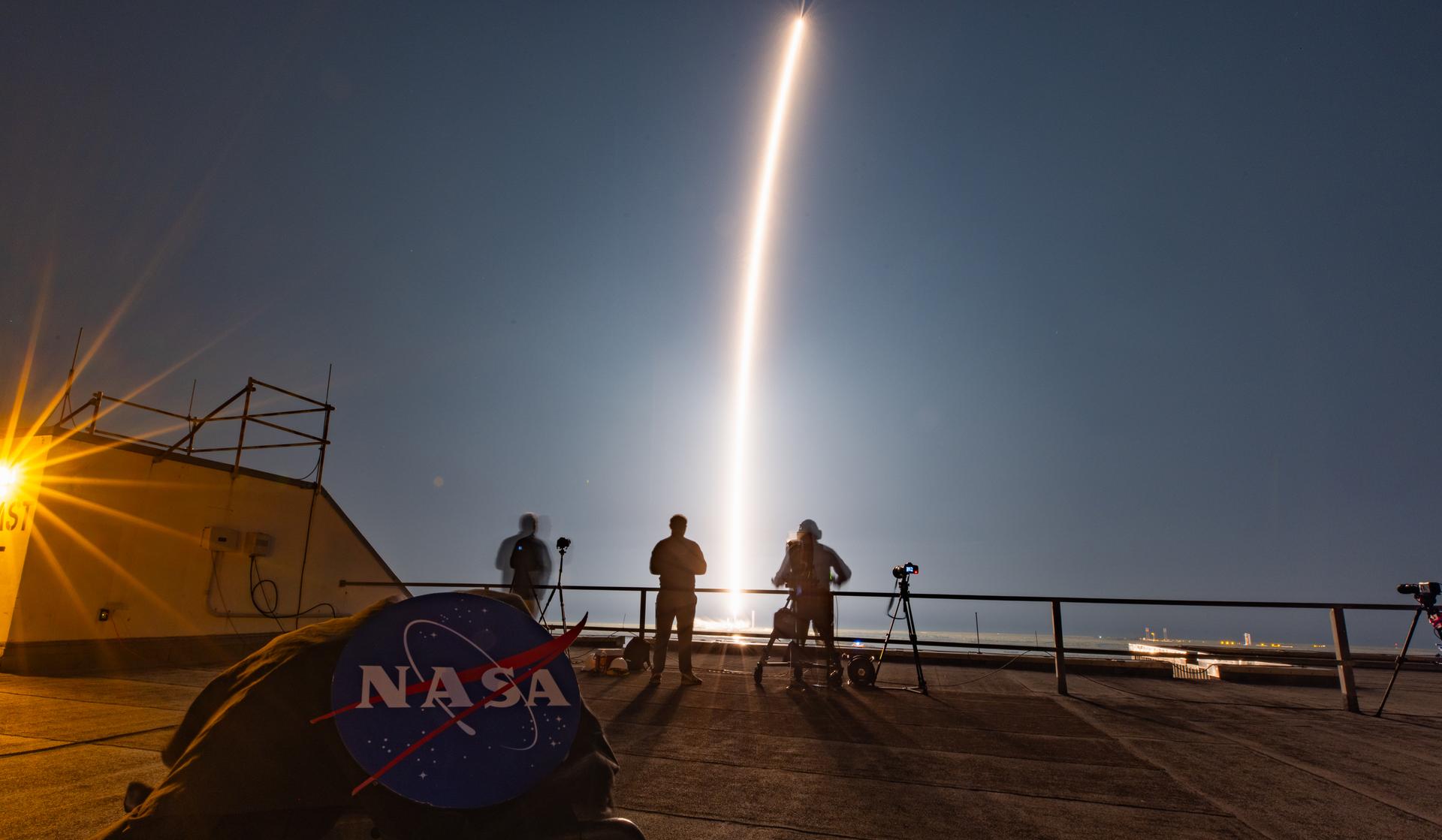 Image shows the NASA emblem with a golden streak from the launch of a SpaceX Falcon 9 rocket carrying Intuitive Machines' Nova-C lunar lander on Wednesday, Feb. 26, 2025.