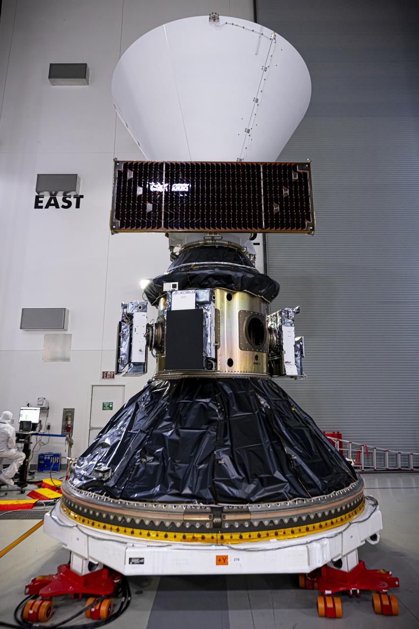 Technicians and engineers encapsulate NASA’s SPHEREx (Spectro-Photometer for the History of the Universe, Epoch of Reionization and Ices Explorer) observatory and PUNCH (Polarimeter to Unify the Corona and Heliosphere) satellites within a protective payload fairing inside the Astrotech Space Operations facility at Vandenberg Space Force Base in California, on Thursday, Feb. 27, 2025.   SPHEREx will use its telescope to provide an all-sky spectral survey, creating a 3D map of the entire sky to help scientists investigate the origins of our universe. PUNCH will study origins of the Sun’s outflow of material, or the solar wind, capturing continuous 3D images of the Sun’s corona and the solar wind’s journey into the solar system. Liftoff aboard a SpaceX Falcon 9 rocket is targeted for NET 10:09 EST (7:09 p.m. PST), Tuesday, March 4, 2025, at Space Launch Complex 4 East from Vandenberg Space Force Base in California.