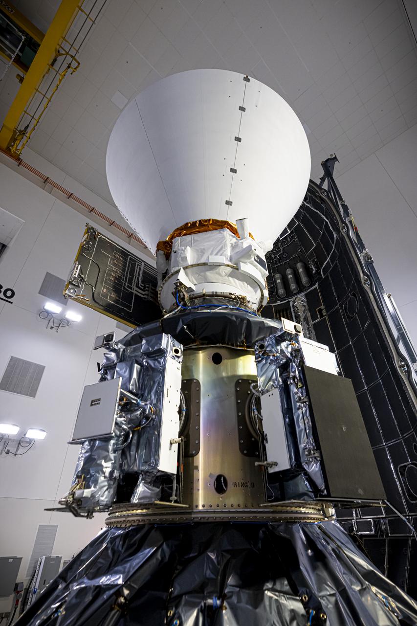 Technicians and engineers encapsulate NASA’s SPHEREx (Spectro-Photometer for the History of the Universe, Epoch of Reionization and Ices Explorer) observatory and PUNCH (Polarimeter to Unify the Corona and Heliosphere) satellites within a protective payload fairing inside the Astrotech Space Operations facility at Vandenberg Space Force Base in California, on Thursday, Feb. 27, 2025.   SPHEREx will use its telescope to provide an all-sky spectral survey, creating a 3D map of the entire sky to help scientists investigate the origins of our universe. PUNCH will study origins of the Sun’s outflow of material, or the solar wind, capturing continuous 3D images of the Sun’s corona and the solar wind’s journey into the solar system. Liftoff aboard a SpaceX Falcon 9 rocket is targeted for NET 10:09 EST (7:09 p.m. PST), Tuesday, March 4, 2025, at Space Launch Complex 4 East from Vandenberg Space Force Base in California.