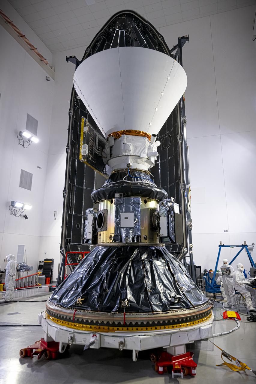 Technicians and engineers encapsulate NASA’s SPHEREx (Spectro-Photometer for the History of the Universe, Epoch of Reionization and Ices Explorer) observatory and PUNCH (Polarimeter to Unify the Corona and Heliosphere) satellites within a protective payload fairing inside the Astrotech Space Operations facility at Vandenberg Space Force Base in California, on Thursday, Feb. 27, 2025.   SPHEREx will use its telescope to provide an all-sky spectral survey, creating a 3D map of the entire sky to help scientists investigate the origins of our universe. PUNCH will study origins of the Sun’s outflow of material, or the solar wind, capturing continuous 3D images of the Sun’s corona and the solar wind’s journey into the solar system. Liftoff aboard a SpaceX Falcon 9 rocket is targeted for NET 10:09 EST (7:09 p.m. PST), Tuesday, March 4, 2025, at Space Launch Complex 4 East from Vandenberg Space Force Base in California.