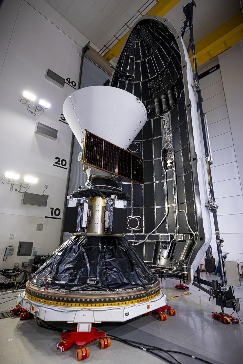 Technicians and engineers encapsulate NASA’s SPHEREx (Spectro-Photometer for the History of the Universe, Epoch of Reionization and Ices Explorer) observatory and PUNCH (Polarimeter to Unify the Corona and Heliosphere) satellites within a protective payload fairing inside the Astrotech Space Operations facility at Vandenberg Space Force Base in California, on Thursday, Feb. 27, 2025.   SPHEREx will use its telescope to provide an all-sky spectral survey, creating a 3D map of the entire sky to help scientists investigate the origins of our universe. PUNCH will study origins of the Sun’s outflow of material, or the solar wind, capturing continuous 3D images of the Sun’s corona and the solar wind’s journey into the solar system. Liftoff aboard a SpaceX Falcon 9 rocket is targeted for NET 10:09 EST (7:09 p.m. PST), Tuesday, March 4, 2025, at Space Launch Complex 4 East from Vandenberg Space Force Base in California.