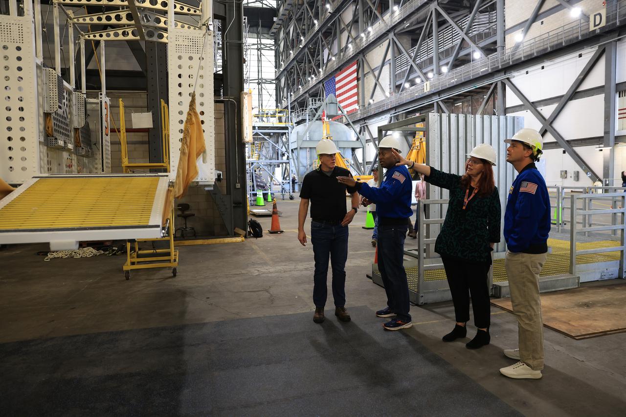 From left, Jeremy Graeber, Artemis assistant launch director Exploration Ground Systems at NASA’s Kennedy Space Center in Florida; NASA astronaut Andre Douglas, Artemis II backup crew member; Charlie Blackwell-Thompson, launch director for NASA’s Exploration Ground Systems Program at Kennedy Space Center; and Artemis II NASA astronaut Reid Wiseman, commander, look at the emergency egress basket inside the Vehicle Assembly Building at NASA Kennedy on Thursday, Feb. 27, 2025. For Artemis II, four astronauts will venture around the Moon, the first crewed mission on NASA’s path to establishing a long-term presence for science and exploration through Artemis.