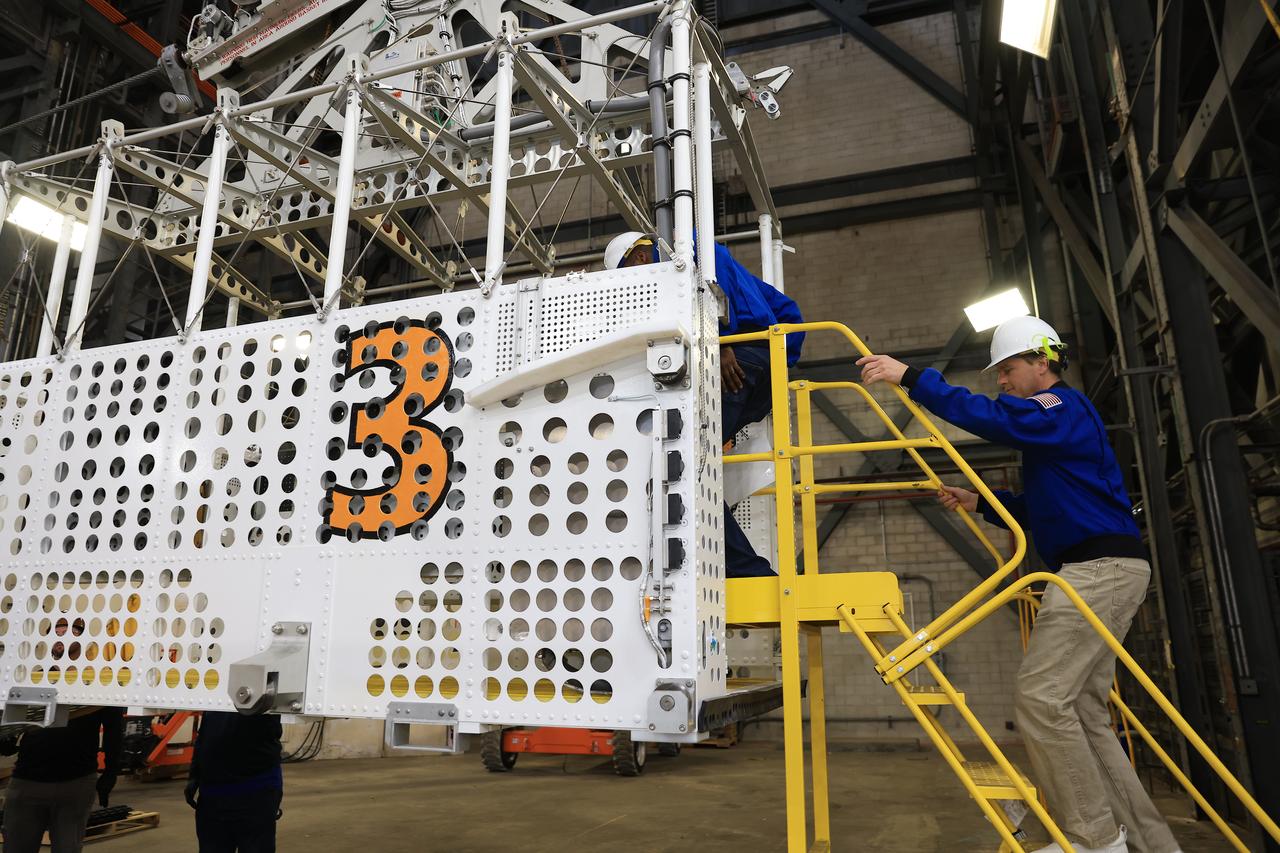 From left, NASA astronauts Andre Douglas, Artemis II backup crew member and Artemis II astronaut Reid Wiseman, commander, practice climbing into an emergency egress basket inside the Vehicle Assembly Building at NASA’s Kennedy Space Center in Florida on Thursday, Feb. 27, 2025. The baskets, similar to gondolas on ski lifts, are used in the case of a pad abort emergency to enable astronauts and other pad personnel a way to quickly escape away from the mobile launcher to the base of the pad and where waiting emergency transport vehicles will then drive them away. For Artemis II, four astronauts will venture around the Moon, the first crewed mission on NASA’s path to establishing a long-term presence for science and exploration through Artemis.