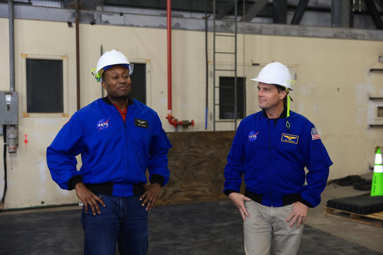 From left, NASA astronauts Andre Douglas, Artemis II backup crew member, and Artemis II astronaut Reid Wiseman, commander tour Artemis II operations inside the Vehicle Assembly Building at NASA Kennedy Space Center in Florida on Thursday, Feb. 27, 2025. For Artemis II, four astronauts will venture around the Moon, the first crewed mission on NASA’s path to establishing a long-term presence for science and exploration through Artemis.