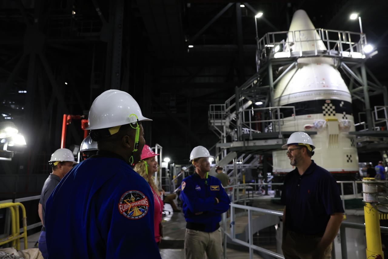 From left, NASA astronauts Andre Douglas, Artemis II backup crew member, and Artemis II astronaut Reid Wiseman, commander; and Artemis team members tour the twin SLS (Space Launch System) solid rocket boosters for Artemis II inside the Vehicle Assembly Building at NASA Kennedy on Thursday, Feb. 27, 2025. For Artemis II, four astronauts will venture around the Moon, the first crewed mission on NASA’s path to establishing a long-term presence for science and exploration through Artemis.