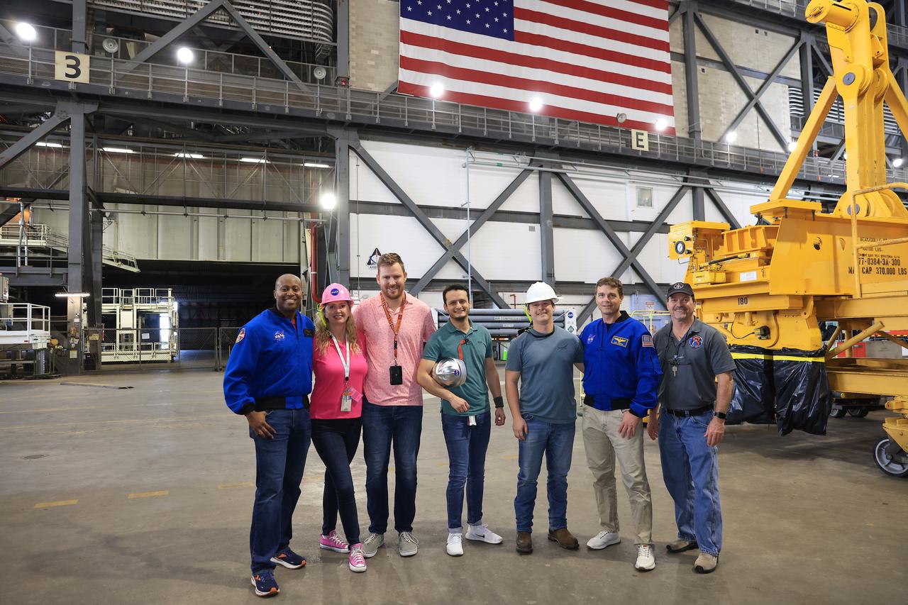 NASA astronauts Andre Douglas (far left), Artemis II backup crew member, and Reid Wiseman, Artemis II commander, pose for a photo during Artemis II tour operations inside the Vehicle Assembly Building at NASA Kennedy on Thursday, Feb. 27, 2025. For Artemis II, four astronauts will venture around the Moon, the first crewed mission on NASA’s path to establishing a long-term presence for science and exploration through Artemis.