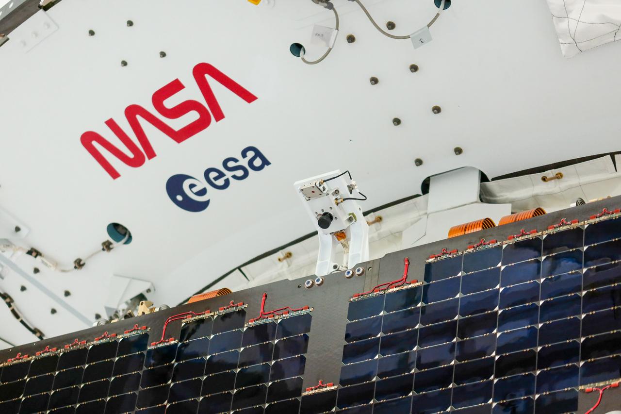 Technicians install four solar array wings on NASA’s Artemis II Orion spacecraft inside the Neil A. Armstrong Operations and Checkout Building at NASA’s Kennedy Space Center in Florida on Monday, March 3, 2025. Each solar array is nearly 23 feet long and can turn on two axes to remain aligned with the Sun for maximum power. Orion’s solar arrays, manufactured and installed by ESA (European Space Agency) and its contractor Airbus, will deliver power to the service module that provides propulsion, thermal control, and electrical power to the spacecraft, as well as air and water for the crew. 