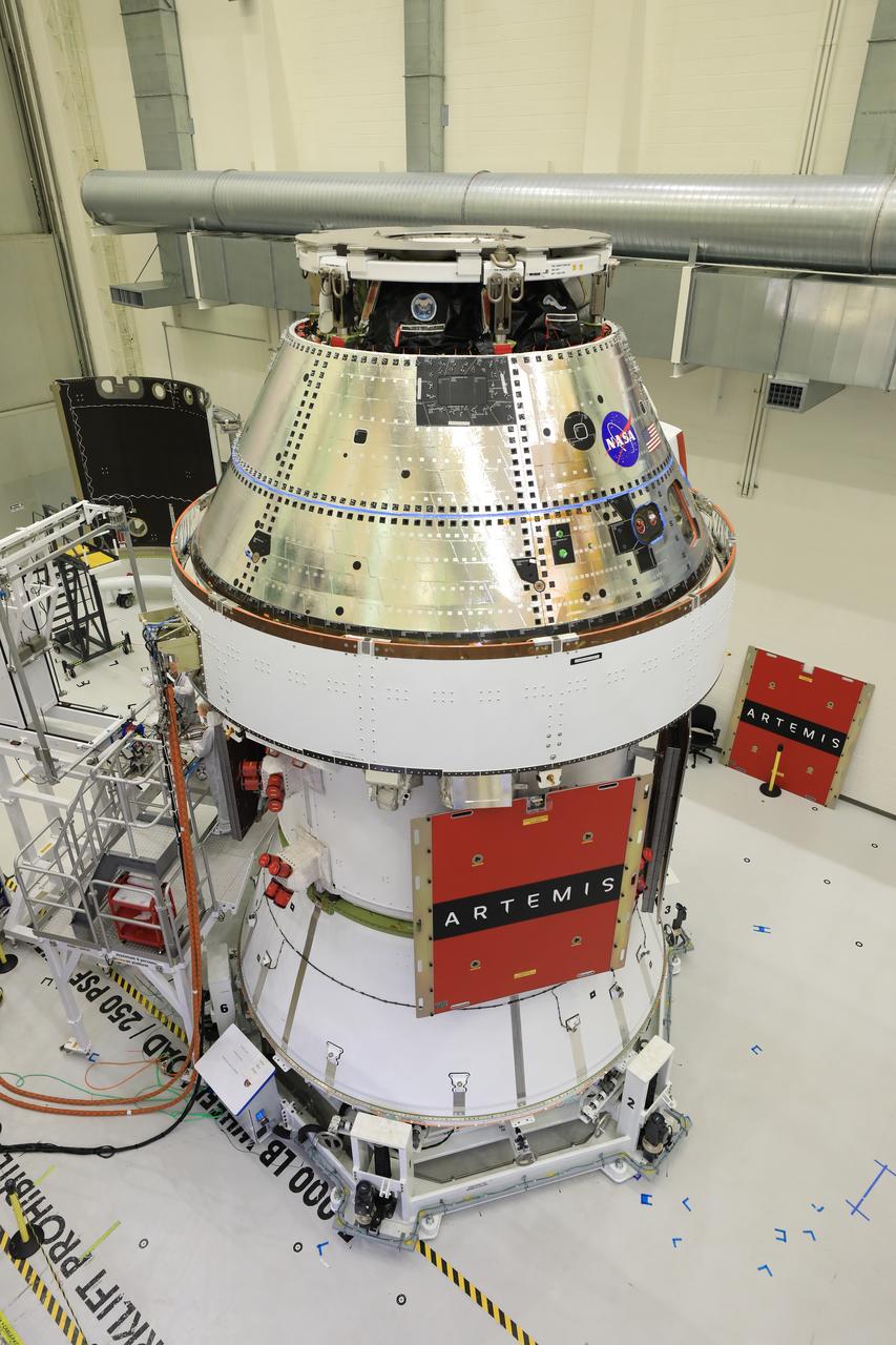 Technicians install four solar array wings on NASA’s Artemis II Orion spacecraft inside the Neil A. Armstrong Operations and Checkout Building at NASA’s Kennedy Space Center in Florida on Monday, March 3, 2025. Each solar array is nearly 23 feet long and can turn on two axes to remain aligned with the Sun for maximum power. Orion’s solar arrays, manufactured and installed by ESA (European Space Agency) and its contractor Airbus, will deliver power to the service module that provides propulsion, thermal control, and electrical power to the spacecraft, as well as air and water for the crew.