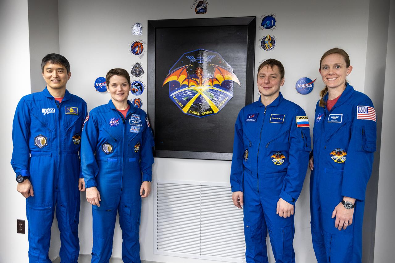 NASA astronauts Anne McClain and Nichole Ayers, along with JAXA (Japan Aerospace Exploration Agency) astronaut Takuya Onishi and Roscosmos cosmonaut Kirill Peskov, pose inside the Astronaut Crew Quarters in the Neil A. Armstrong Operations and Checkout Building at NASA’s Kennedy Space Center in Florida on March 7, 2025. McClain, Ayers, Onishi, and Peskov will launch on NASA’s SpaceX Crew-10 mission – the 10th crew rotation mission of the SpaceX Dragon spacecraft and Falcon 9 rocket that will send the crew to the International Space Station as part of the agency’s Commercial Crew Program. The mission is scheduled to launch no earlier than 7:48 p.m. EDT on Wednesday, March 12, 2025, from NASA Kennedy’s Launch Complex 39A.