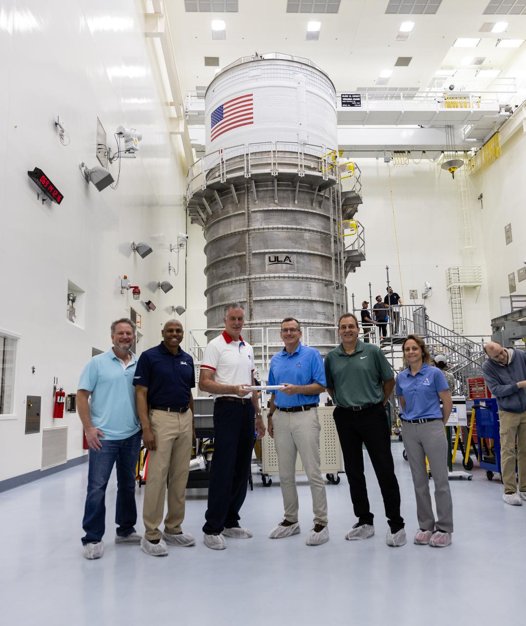 Managers from NASA and industry partners for NASA’s SLS (Space Launch System) rocket upper stage hand off the baton to managers from the agency’s Exploration Ground Systems (EGS) are shown with the SLS interim cryogenic propulsion stage inside the Multi-Payload Processing Facility at NASA’s Kennedy Space Center in Florida on Monday, March 10, 2025, after being transported from United Launch Alliance’s (ULA) Delta Operations Center at nearby Cape Canaveral Space Force Station. From left to right are Jim Bonato, ICPS Mission Manager, ULA; Ron Fortson, Director and General Manager, ULA; Chris Calfee, Spacecraft/Payload Integration and Evolution element manager, SLS; Cliff Lanham, senior vehicle operations manager, EGS; Todd Lamond, Strategic Planning and Integration, Amentum; and Natasha Wiest, Interim Director, Boeing Core Stage Integrated Product Team; The interim cryogenic propulsion stage is a liquid oxygen and liquid hydrogen-based system that will fire its RL10 engine to give the Orion spacecraft the big in-space push needed to fly around the Moon and back. 