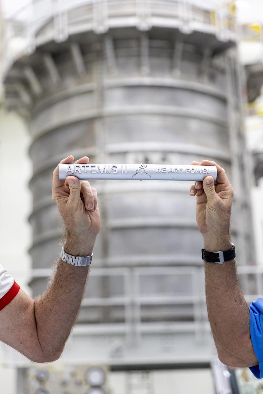 Managers from NASA’s Exploration Ground Systems (EGS) and  SLS (Space Launch System) Programs hold a baton signifying the hand off of the SLS interim cryogenic propulsion stage to Kennedy’s EGS Program inside the Multi-Payload Processing Facility at NASA’s Kennedy Space Center in Florida on Monday, March 10, 2025, after being transported from United Launch Alliance’s Delta Operations Center at nearby Cape Canaveral Space Force Station. Teams with EGS will begin fueling the upper stage inside the facility ahead of the agency’s Artemis II mission. The interim cryogenic propulsion stage is a liquid oxygen and liquid hydrogen-based system that will fire its RL10 engine to give the Orion spacecraft the big in-space push needed to fly around the Moon and back. 