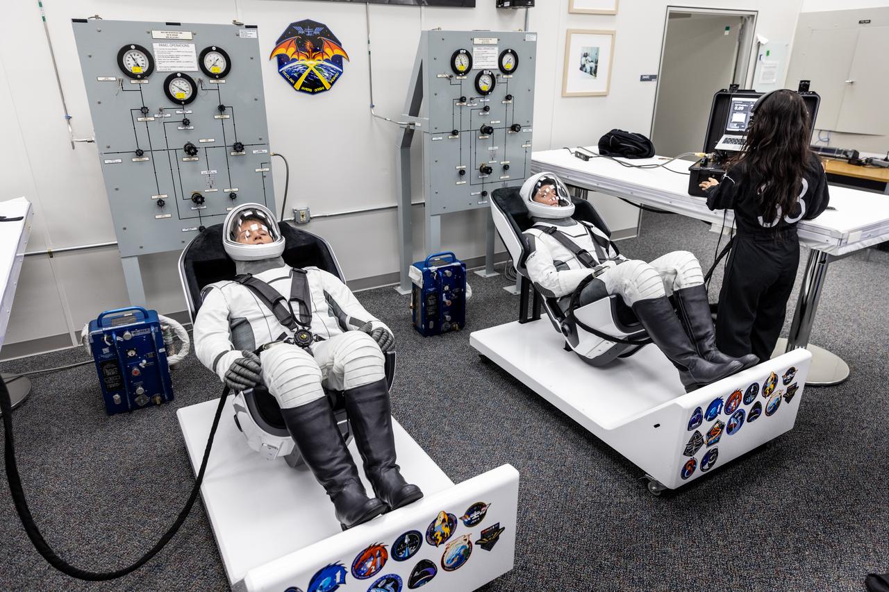 NASA astronauts Anne McClain (left) and Nichole Ayers (right) are photographed in their SpaceX spacesuits inside the crew suit-up room in the Neil A. Armstrong Operations and Checkout Building at the agency’s Kennedy Space Center in Florida ahead of launch of NASA’s SpaceX Crew-10 mission on Wednesday, March 12, 2025. McClain and fellow NASA astronaut Nichole Ayers, along with JAXA (Japan Aerospace Exploration Agency) astronaut Takuya Onishi and Roscosmos cosmonaut Kirill Peskov are scheduled to lift off aboard SpaceX’s Dragon spacecraft and Falcon 9 rocket at 7:48 p.m. EDT, from Launch Complex 39A at NASA Kennedy. Crew-10 is the 10th crew rotation mission with SpaceX to the space station as part of the agency’s Commercial Crew Program.