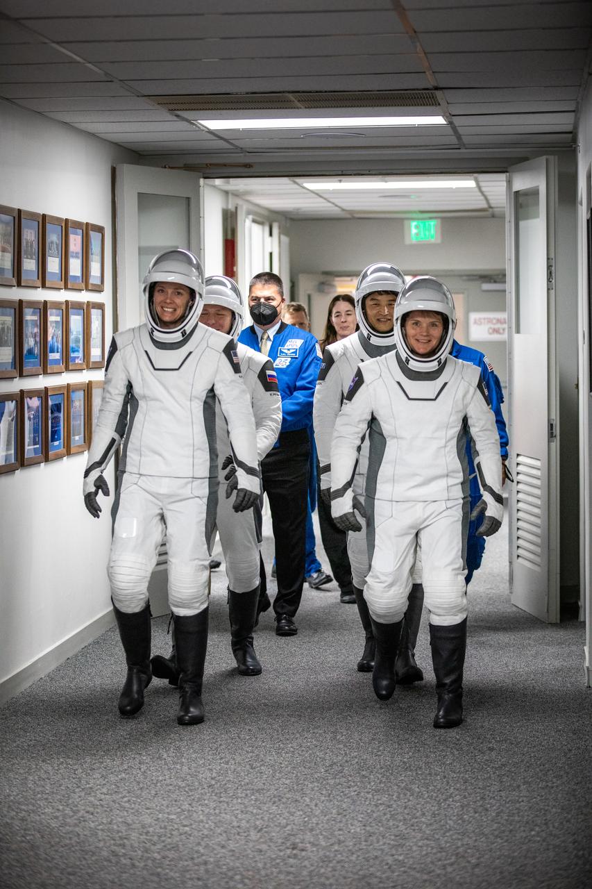 NASA’s SpaceX Crew-10 crew members walk out of the Neil A. Armstrong Operations and Checkout Building at the agency’s Kennedy Space Center in Florida ahead of launch on Wednesday, March 12, 2025. NASA astronauts Nichole Ayers (front, left) and Anne McClain (front, right), along with JAXA (Japan Aerospace Exploration Agency) astronaut Takuya Onishi (second row, right) and Roscosmos cosmonaut Kirill Peskov (second row, left) are scheduled to lift off aboard SpaceX’s Dragon spacecraft and Falcon 9 rocket at 7:48 p.m. EDT, from Launch Complex 39A at NASA Kennedy. Crew-10 is the tenth crew rotation mission with SpaceX to the space station as part of the agency’s Commercial Crew Program.