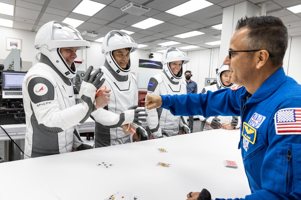 NASA’s SpaceX Crew-10 crew members play the traditional card game with NASA astronaut chief Joe Acaba, inside the Neil A. Armstrong Operations and Checkout Building at the agency’s Kennedy Space Center in Florida ahead of launch to the International Space Station on Friday, March 14, 2025. From left to right, Roscosmos cosmonaut Kirill Peskov, JAXA (Japan Aerospace Exploration Agency) astronaut Takuya Onishi, as well as NASA astronauts Nichole Ayers and Anne McClain are scheduled to lift off aboard SpaceX’s Dragon spacecraft and Falcon 9 rocket at 7:03 p.m. EDT, from Launch Complex 39A at NASA Kennedy. Crew-10 is the 10th crew rotation mission with SpaceX to the space station as part of the agency’s Commercial Crew Program.