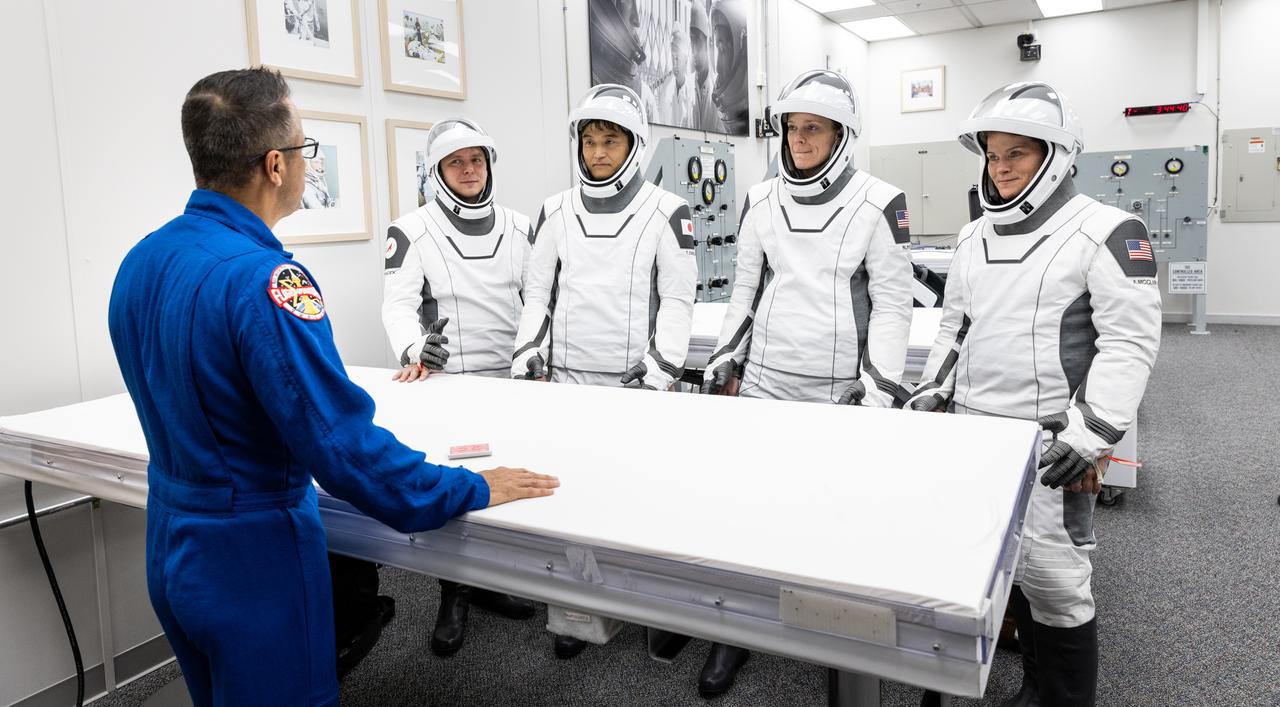 NASA’s SpaceX Crew-10 crew members play the traditional card game with NASA astronaut chief Joe Acaba, inside the Neil A. Armstrong Operations and Checkout Building at the agency’s Kennedy Space Center in Florida ahead of launch to the International Space Station on Friday, March 14, 2025. From left to right, Roscosmos cosmonaut Kirill Peskov, JAXA (Japan Aerospace Exploration Agency) astronaut Takuya Onishi, as well as NASA astronauts Nichole Ayers and Anne McClain are scheduled to lift off aboard SpaceX’s Dragon spacecraft and Falcon 9 rocket at 7:03 p.m. EDT, from Launch Complex 39A at NASA Kennedy. Crew-10 is the 10th crew rotation mission with SpaceX to the space station as part of the agency’s Commercial Crew Program.